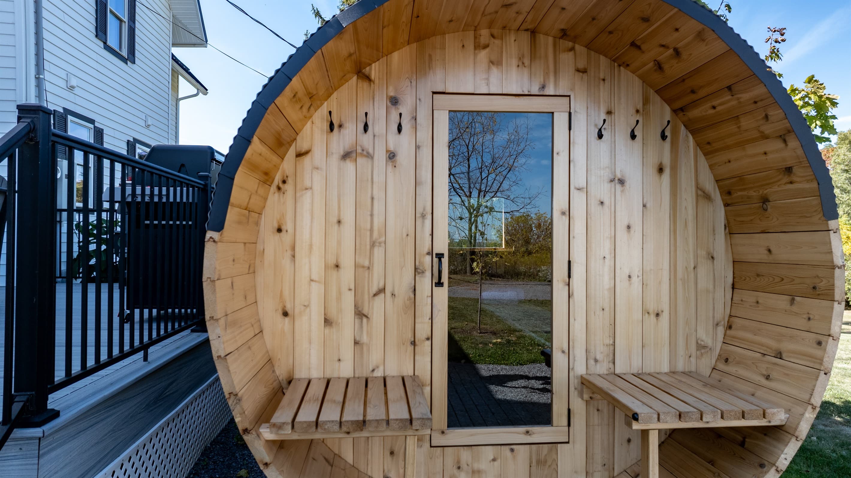Wooden sauna entrance with glass door