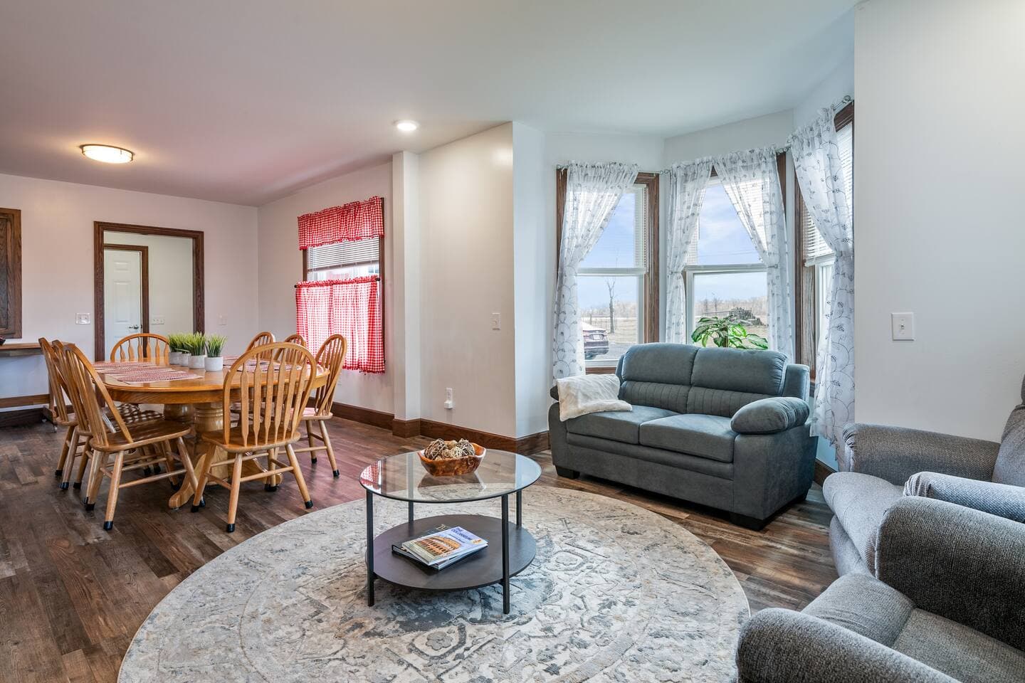Living space viewed beyond wooden dining table