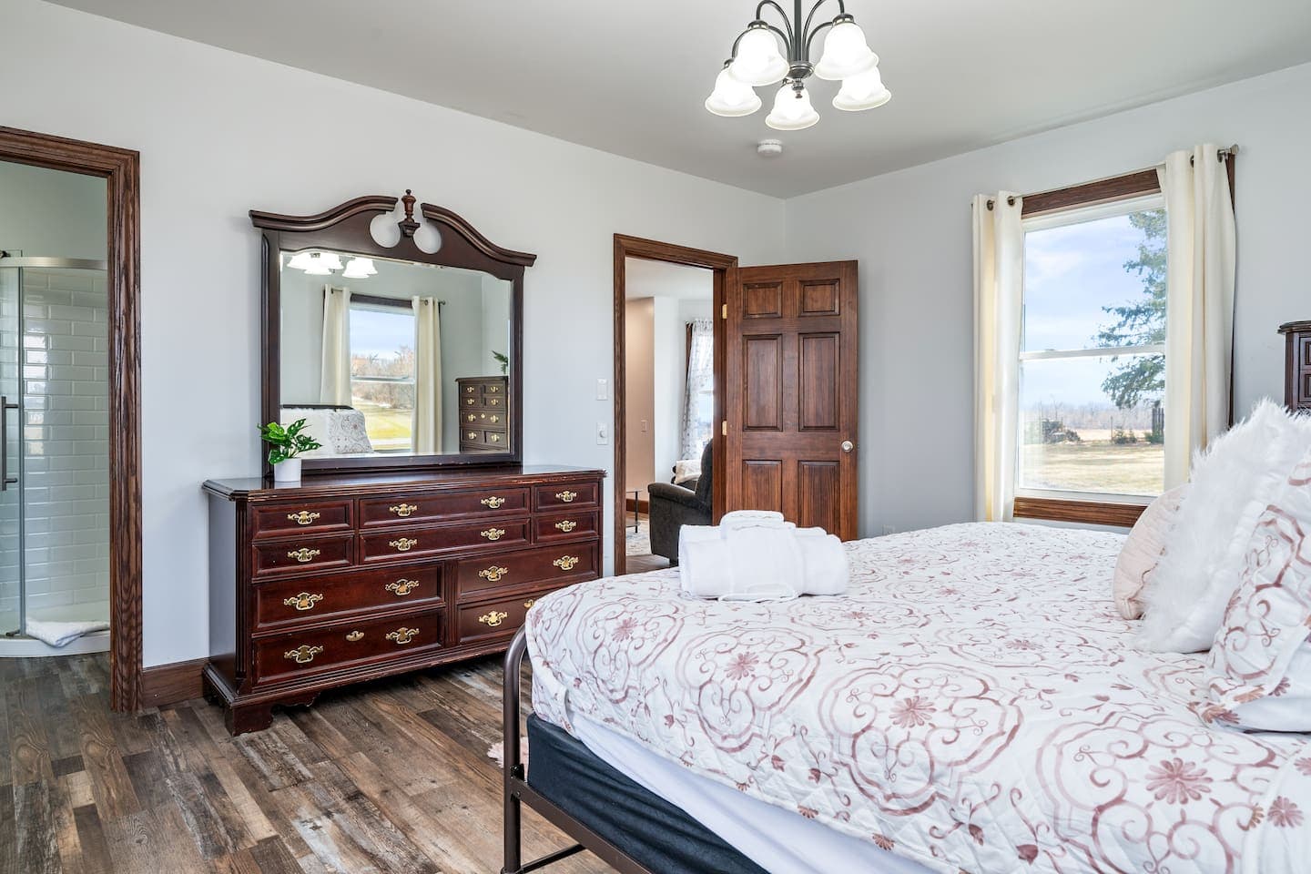 Bedroom dresser beneath framed mirror