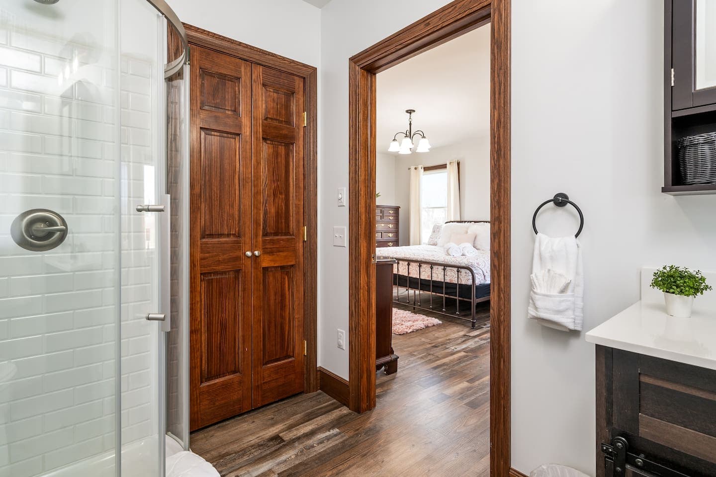 Bathroom vanity beside glass-enclosed shower