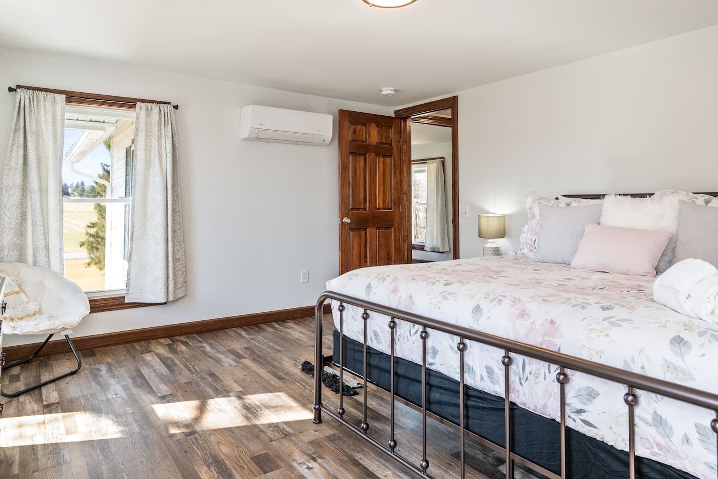 Bedroom with white bedding beside the window