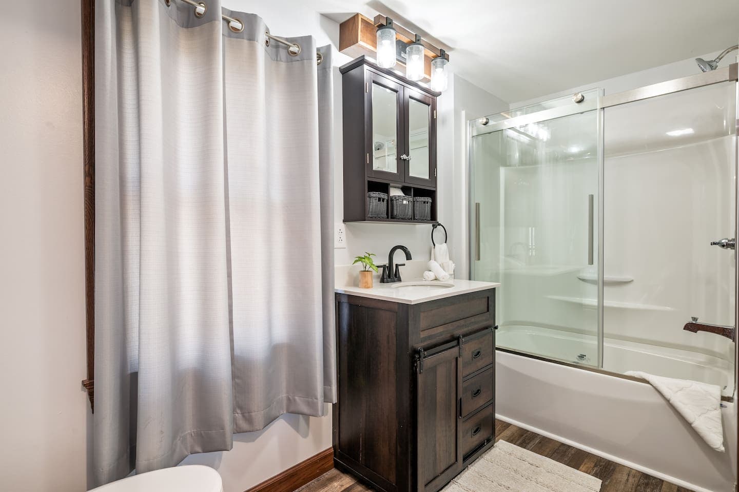 Bathroom with glass shower and dark vanity