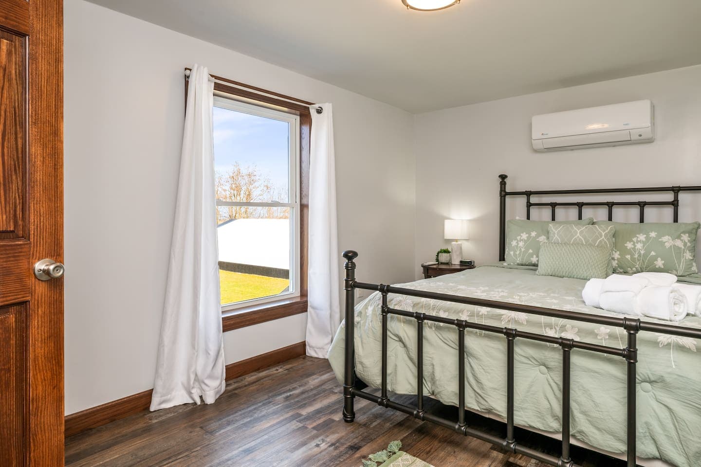 Bright bedroom with window and wood furniture