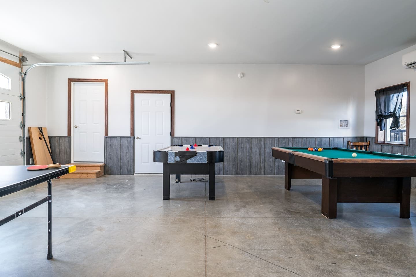 Game room with window and open floor space