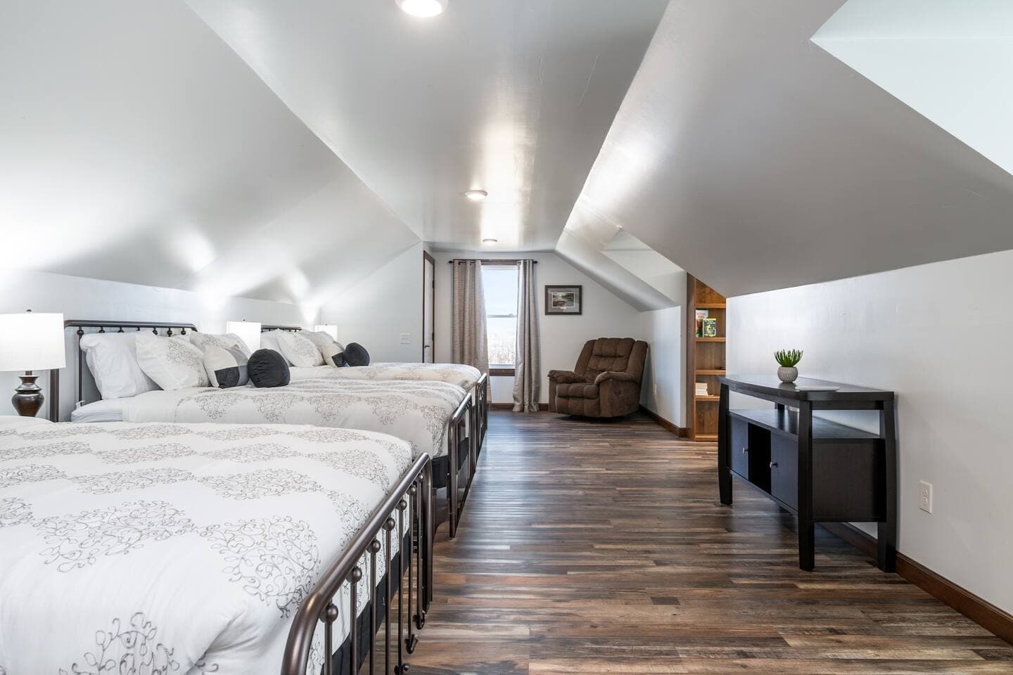 Bedroom with white bedding and dresser