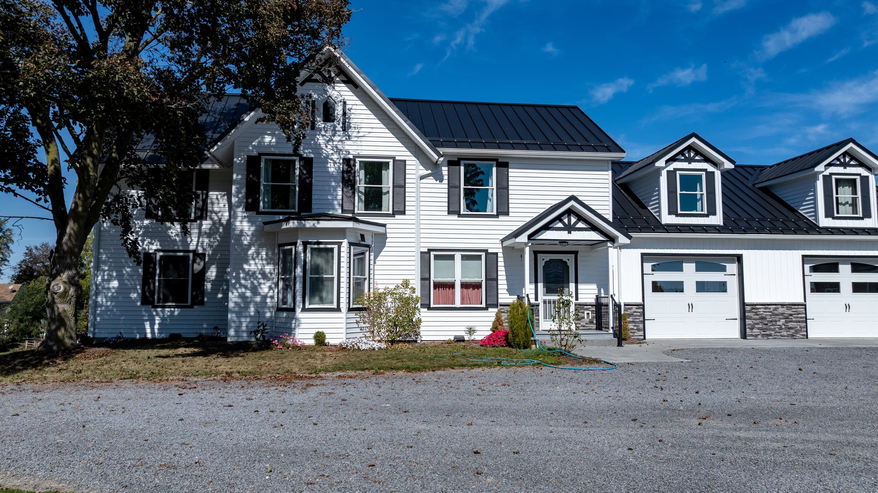 Front exterior with black shutters and porch