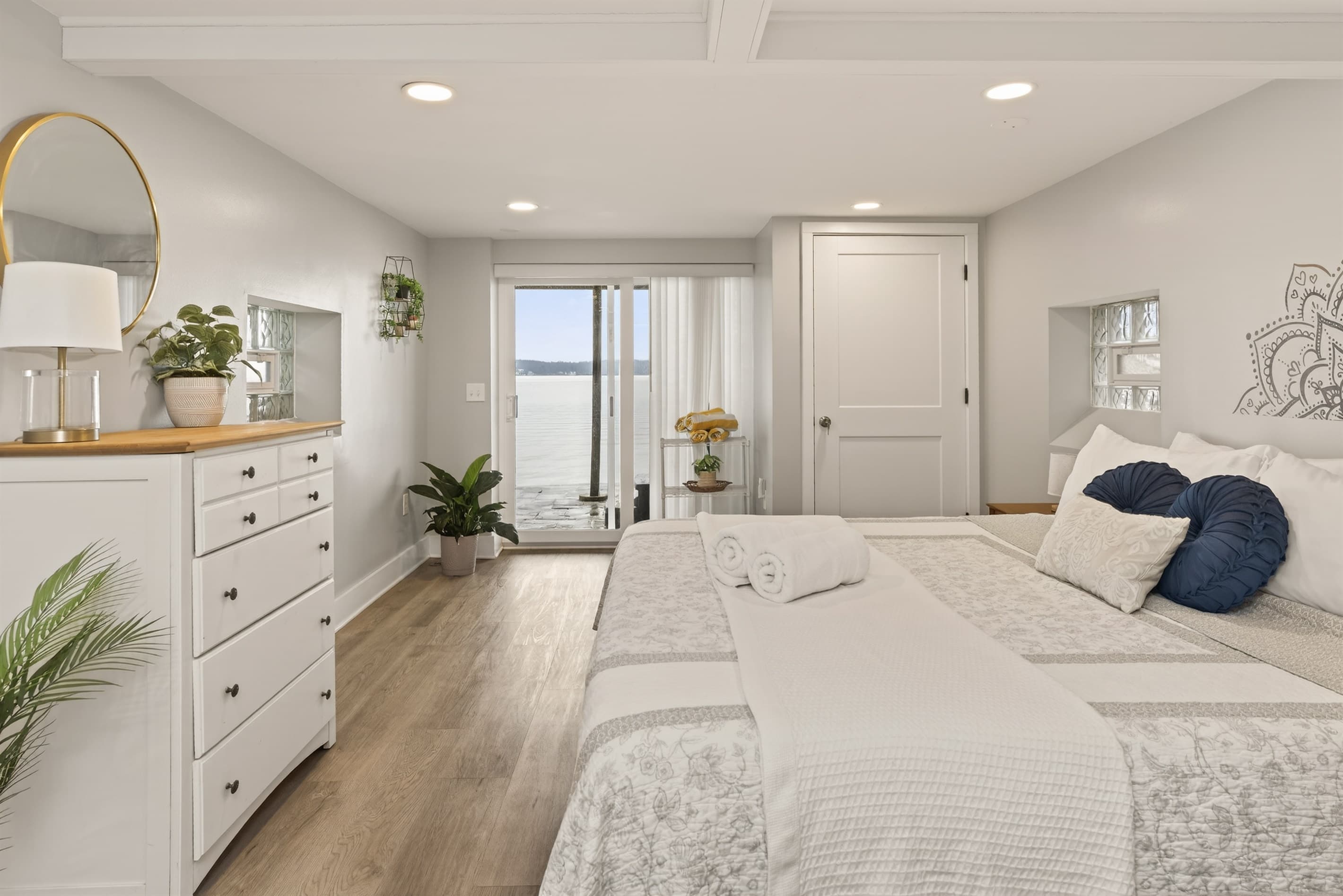 Bright bedroom with a dresser and windows