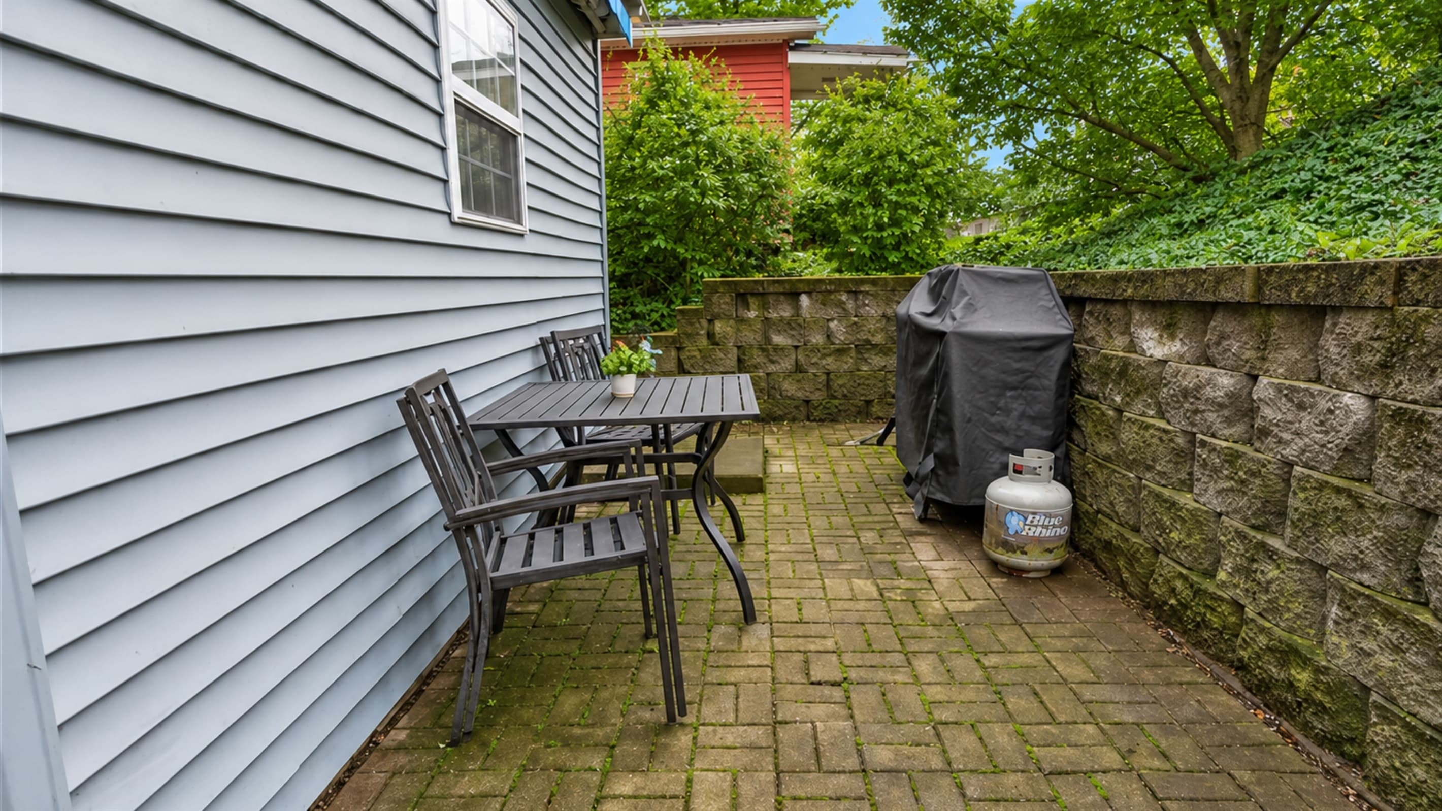Paved patio with grill and dining set