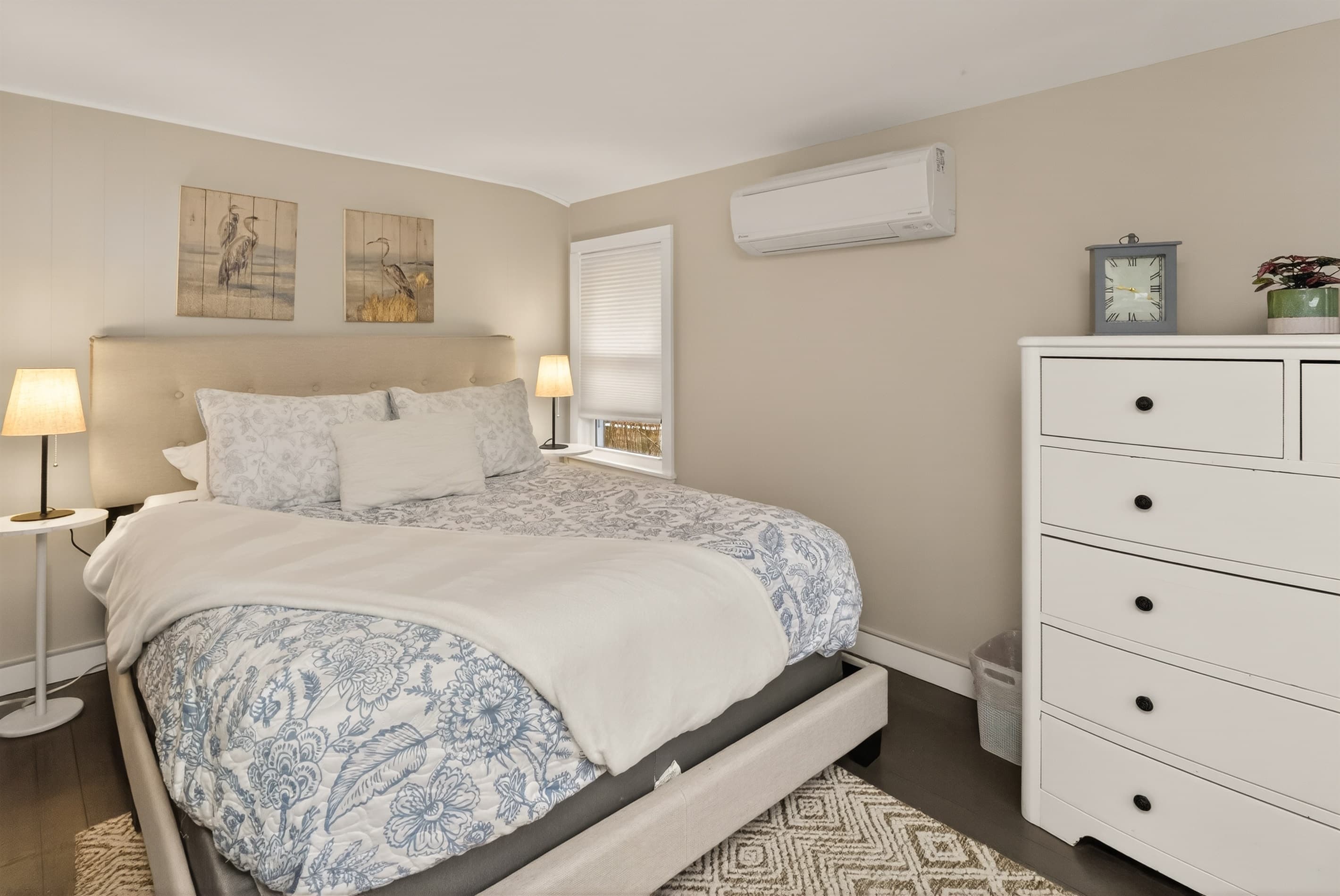 Bedroom with patterned bedding and dresser