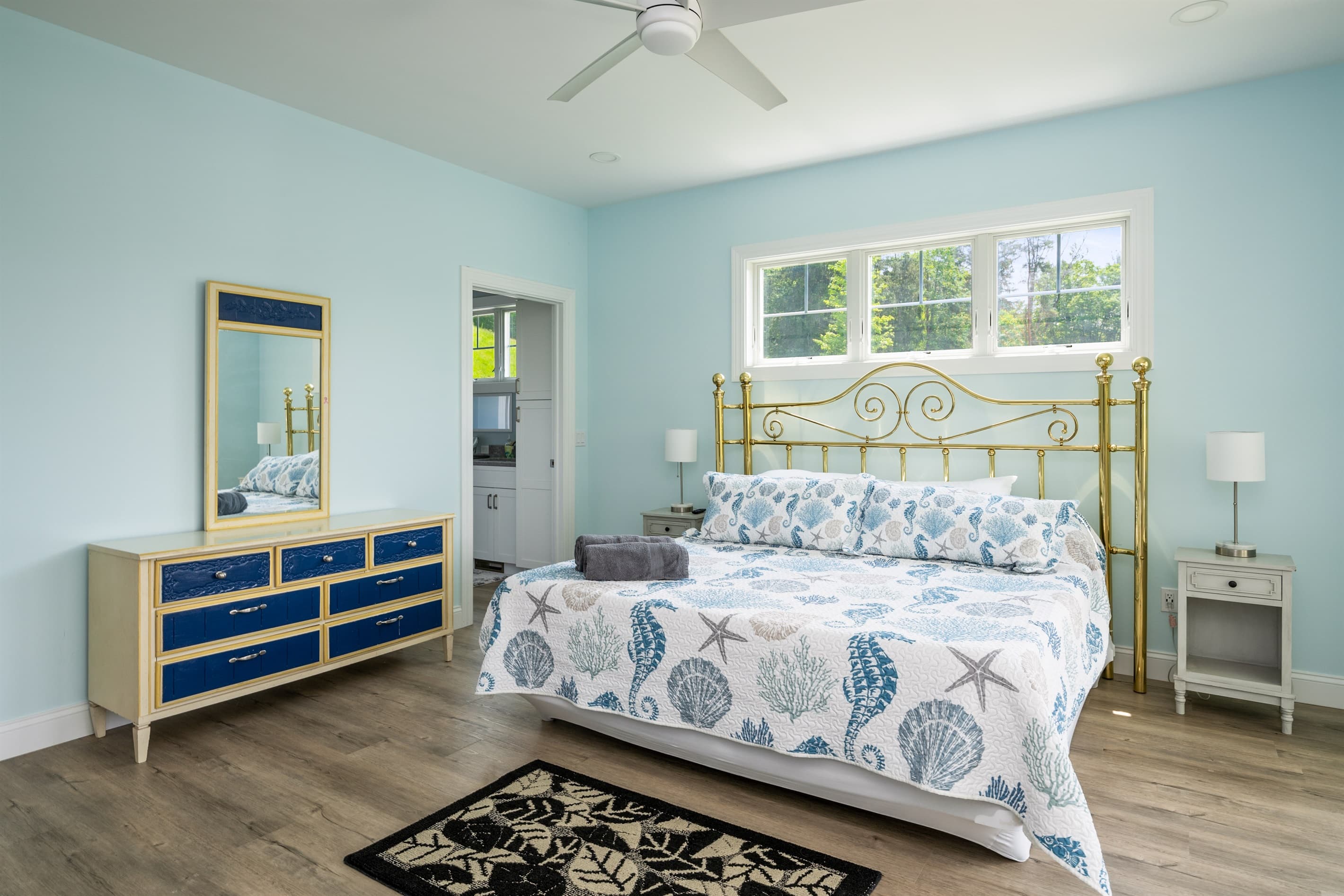 Bed framed by windows and nightstands