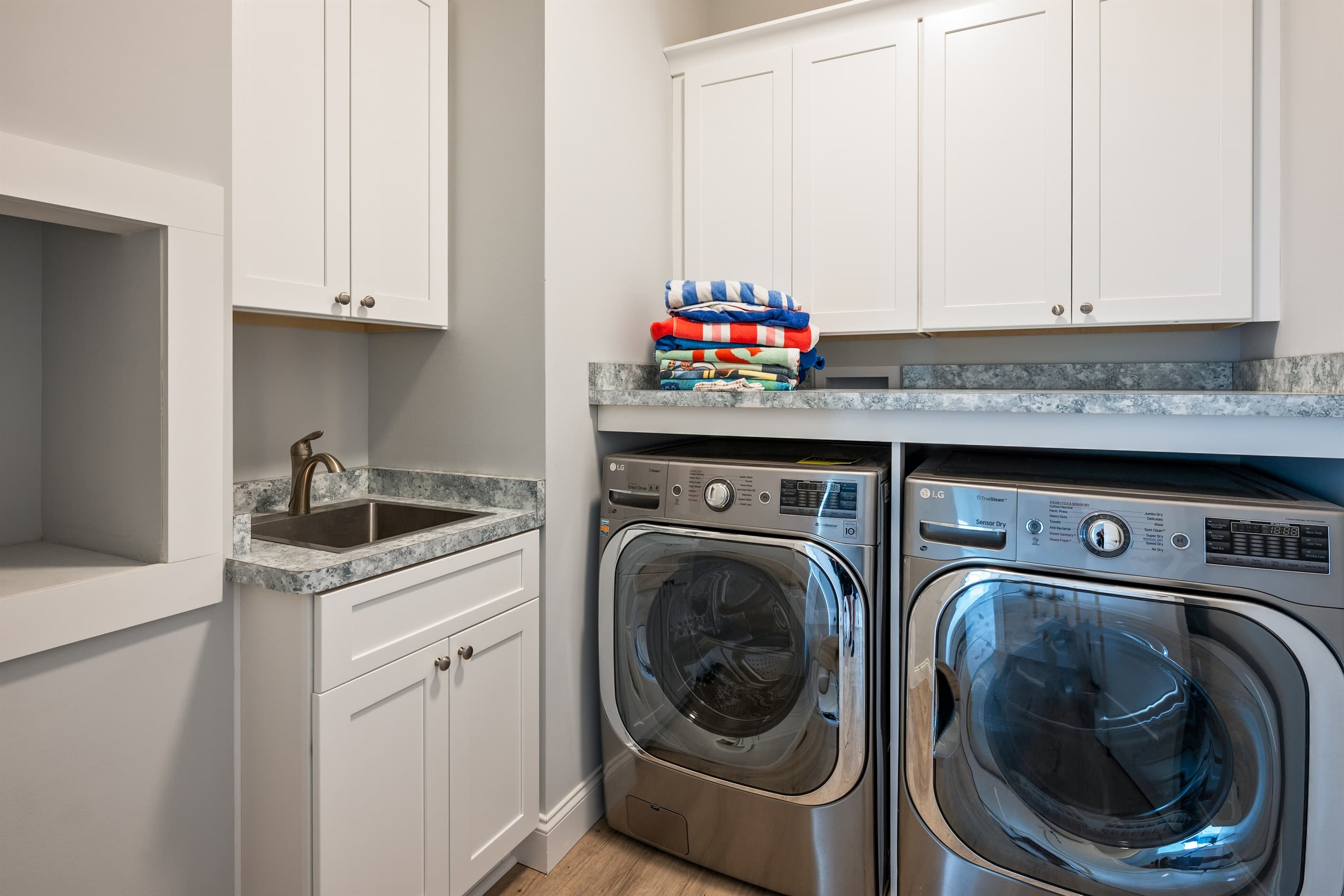 Laundry room with washer, dryer, and sink
