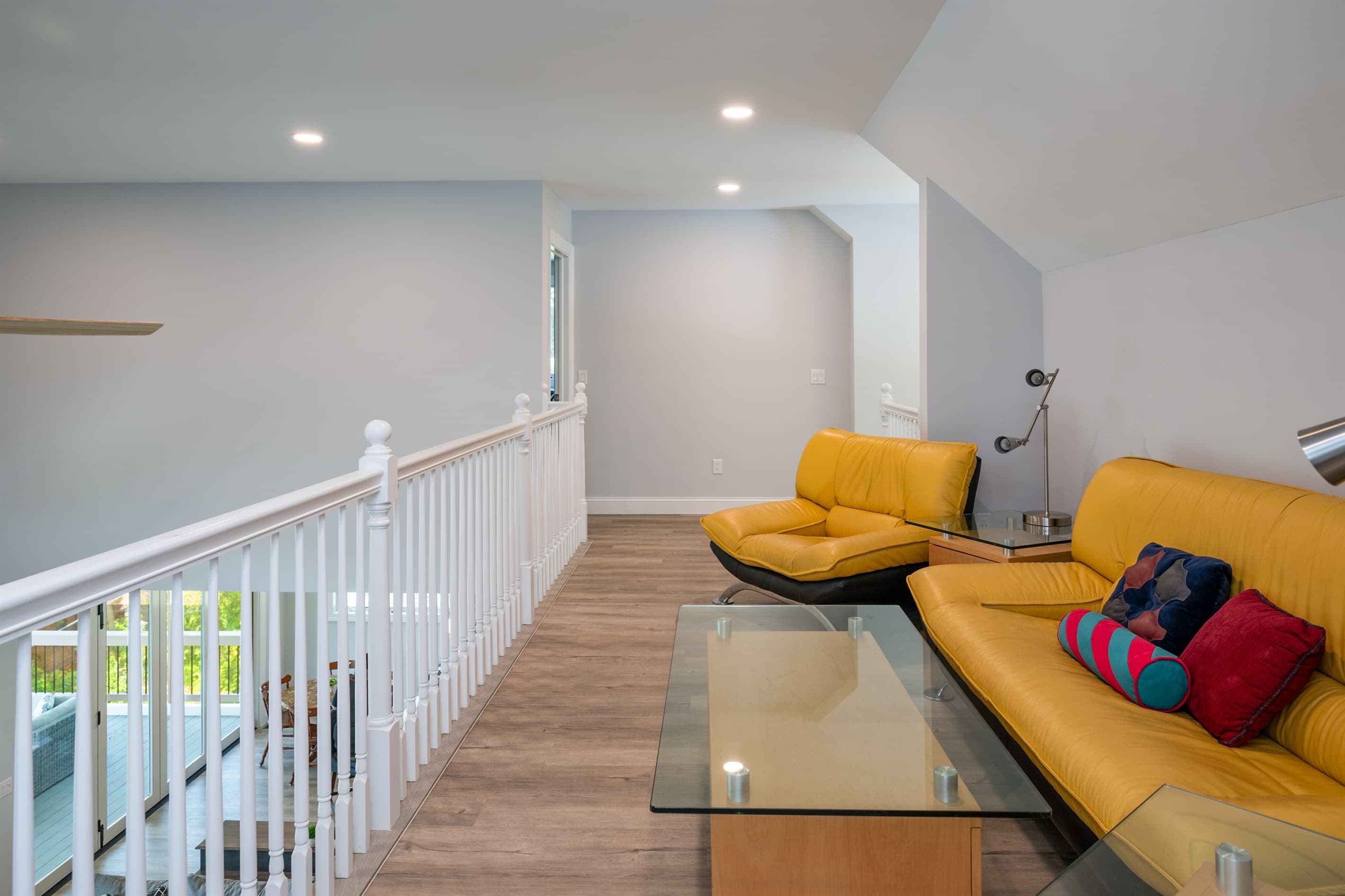 Loft sitting area with yellow chairs
