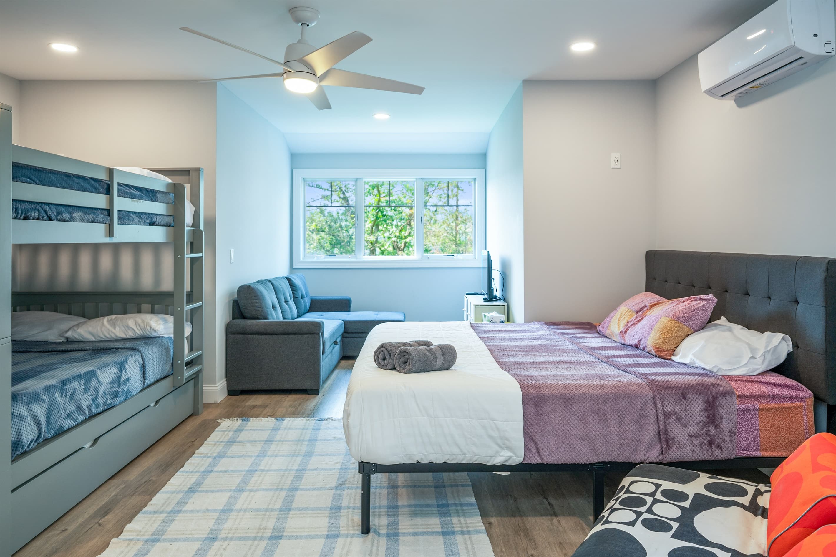 Sleeping area with dresser and multiple beds