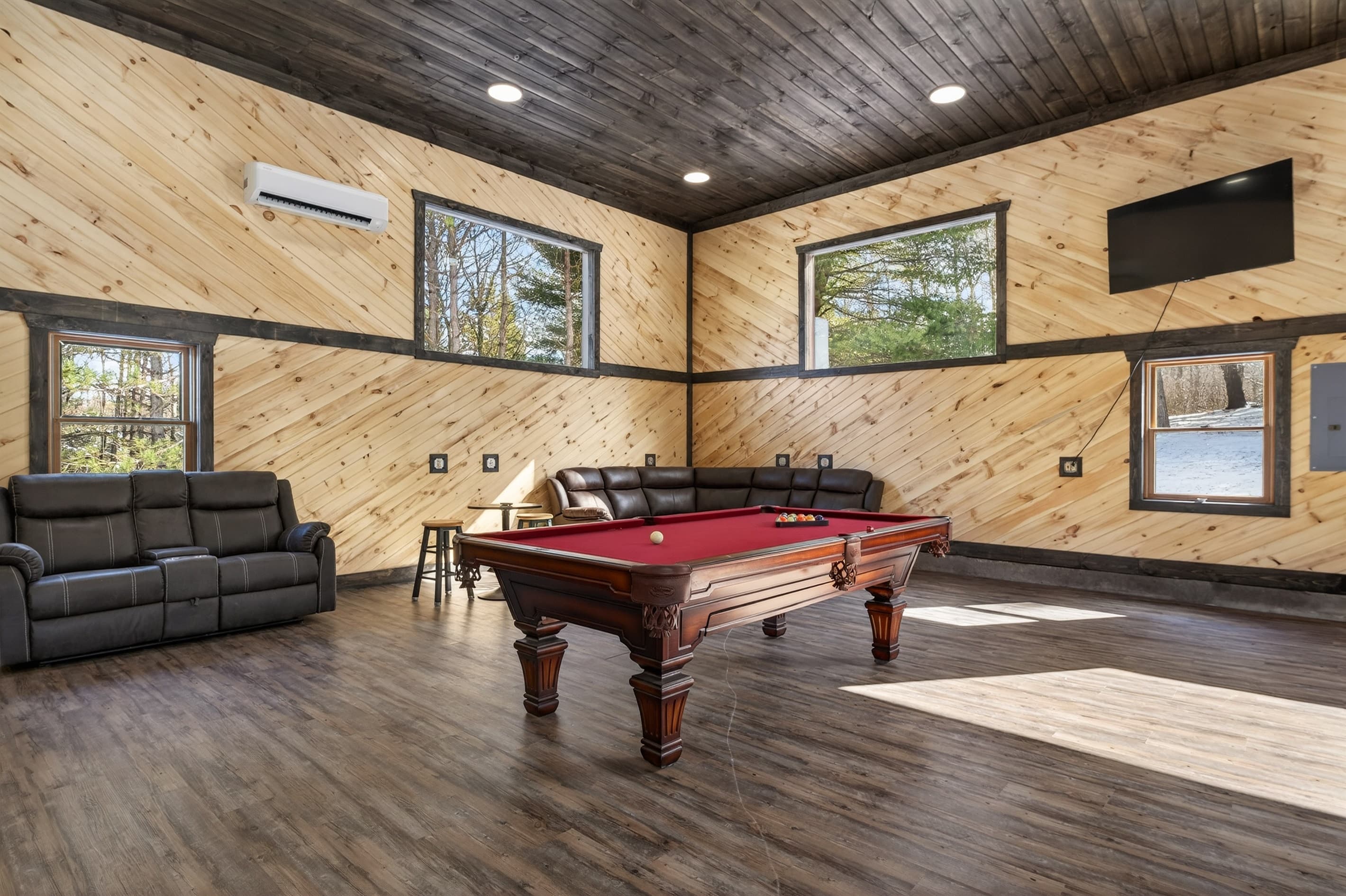 Pool table beneath ceiling windows