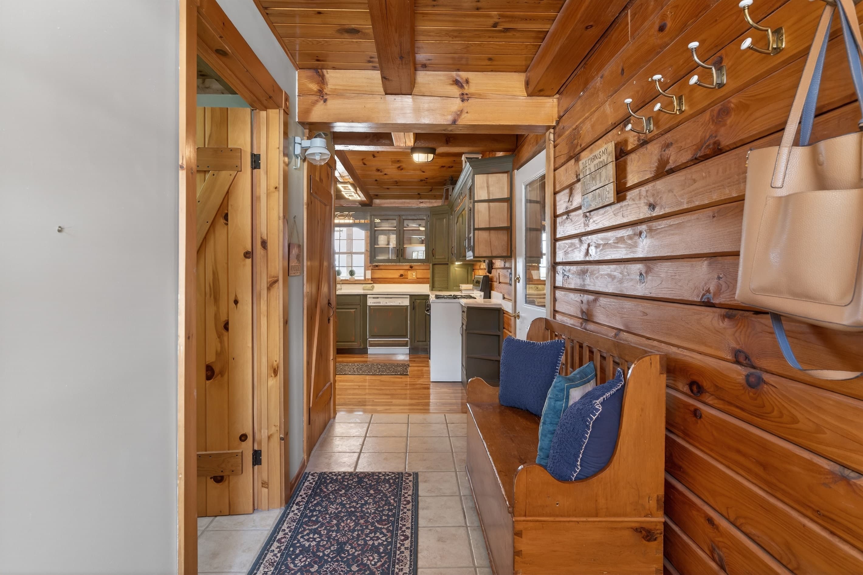 Hallway seating with kitchen visible beyond