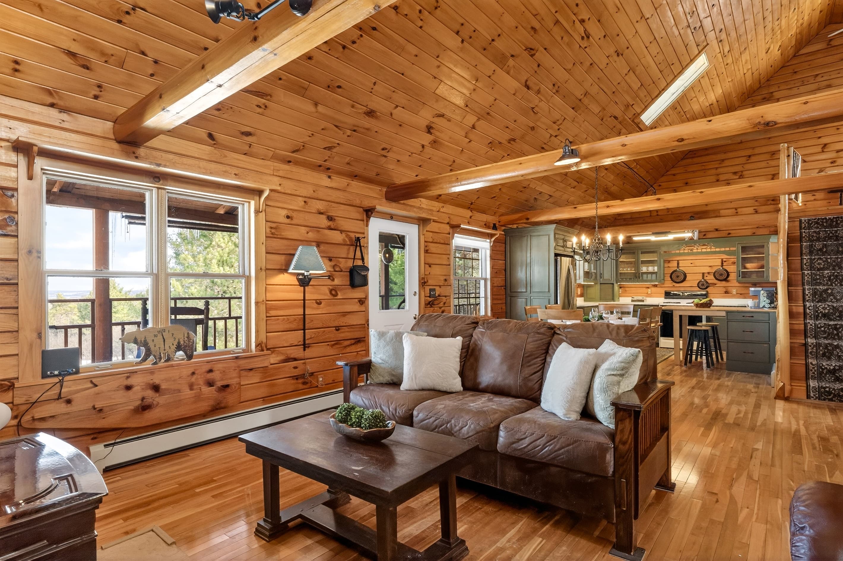 Living room seating with kitchen visible beyond