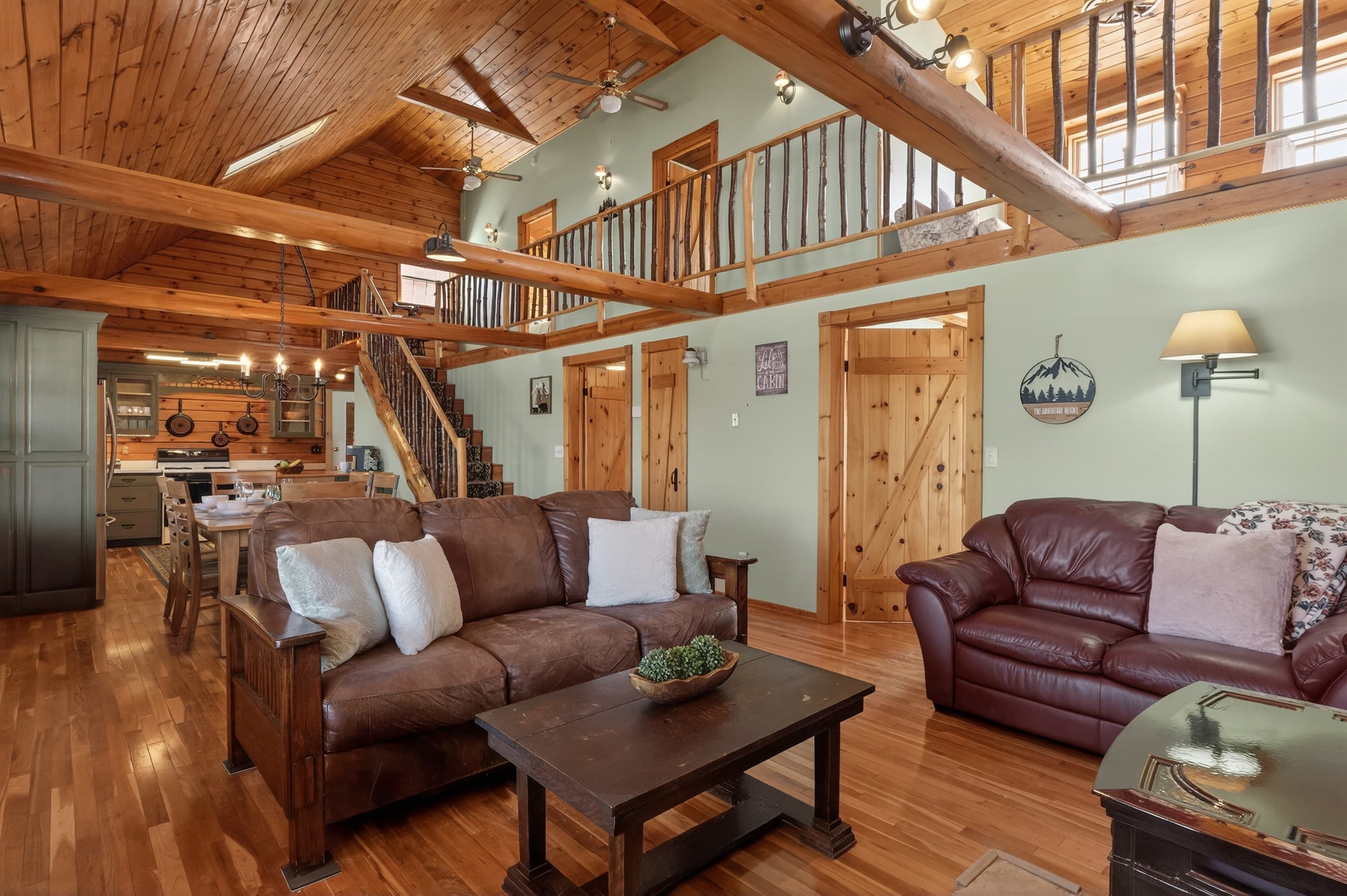 Two sofas beneath the loft railing