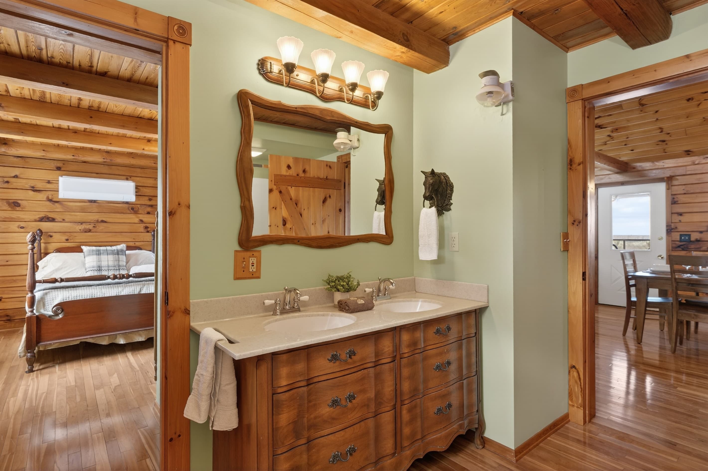 Vanity beneath a wooden-framed mirror