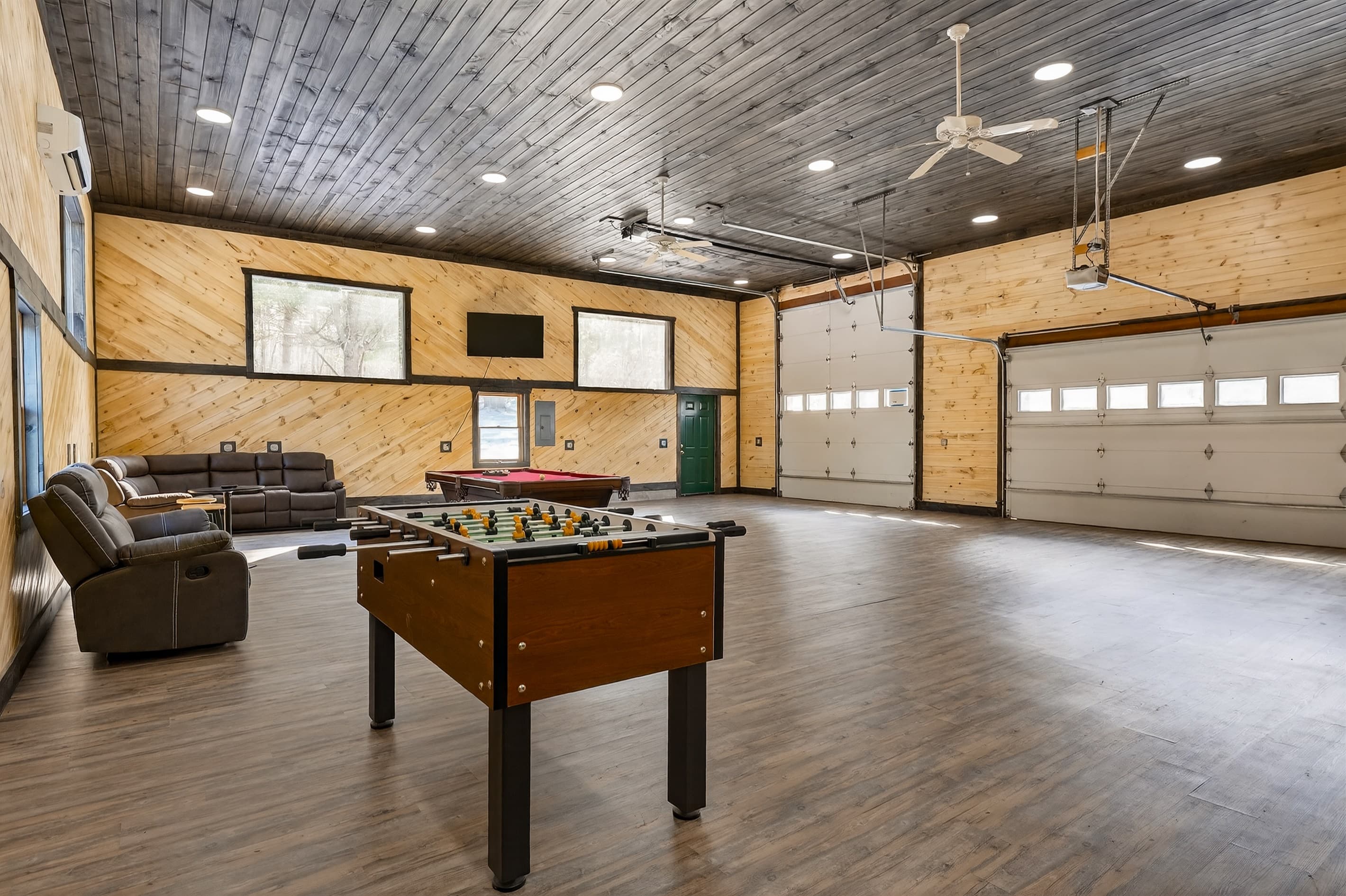 Pool table facing two garage doors
