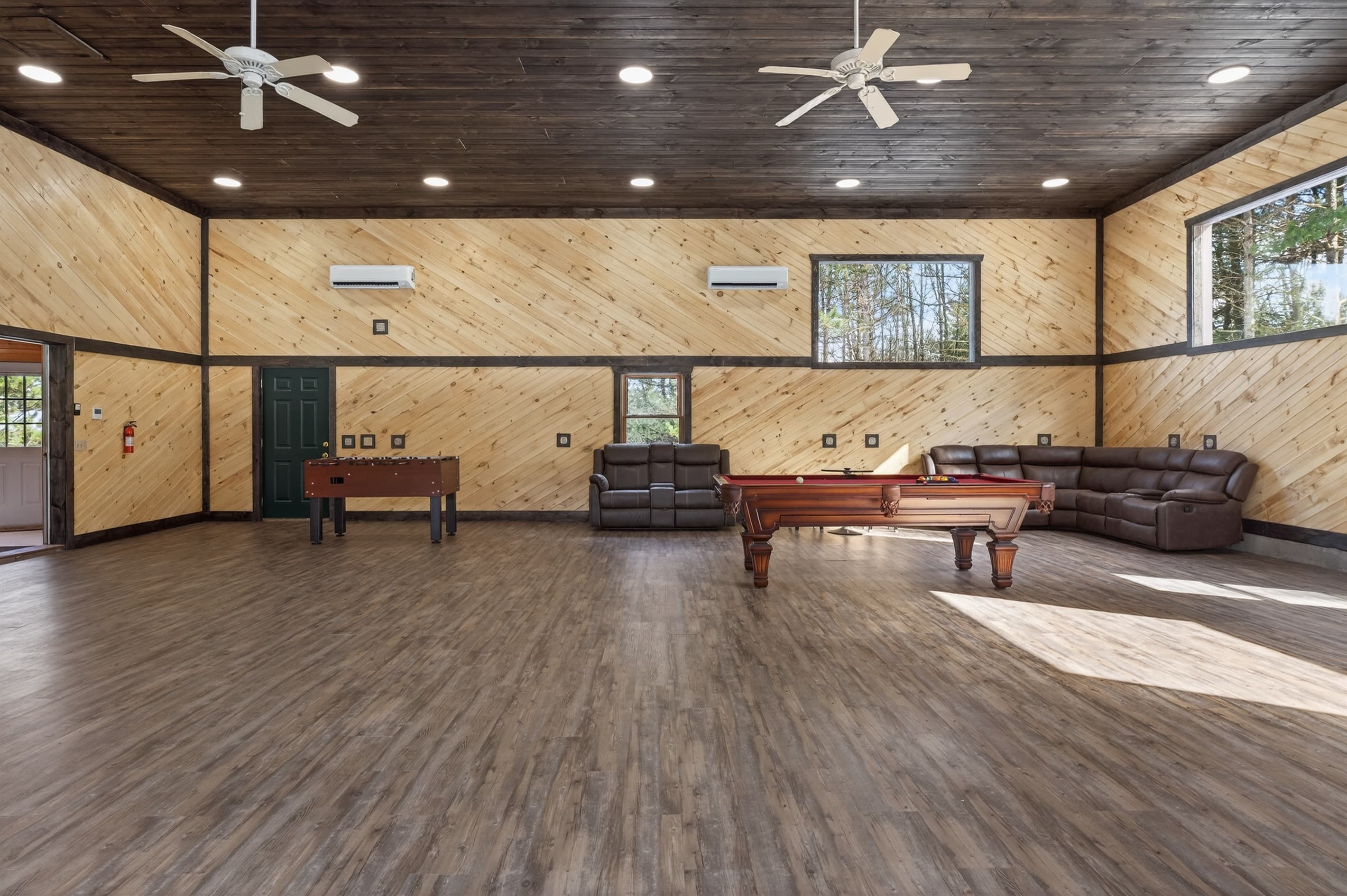 Large game room with pool table and sofas