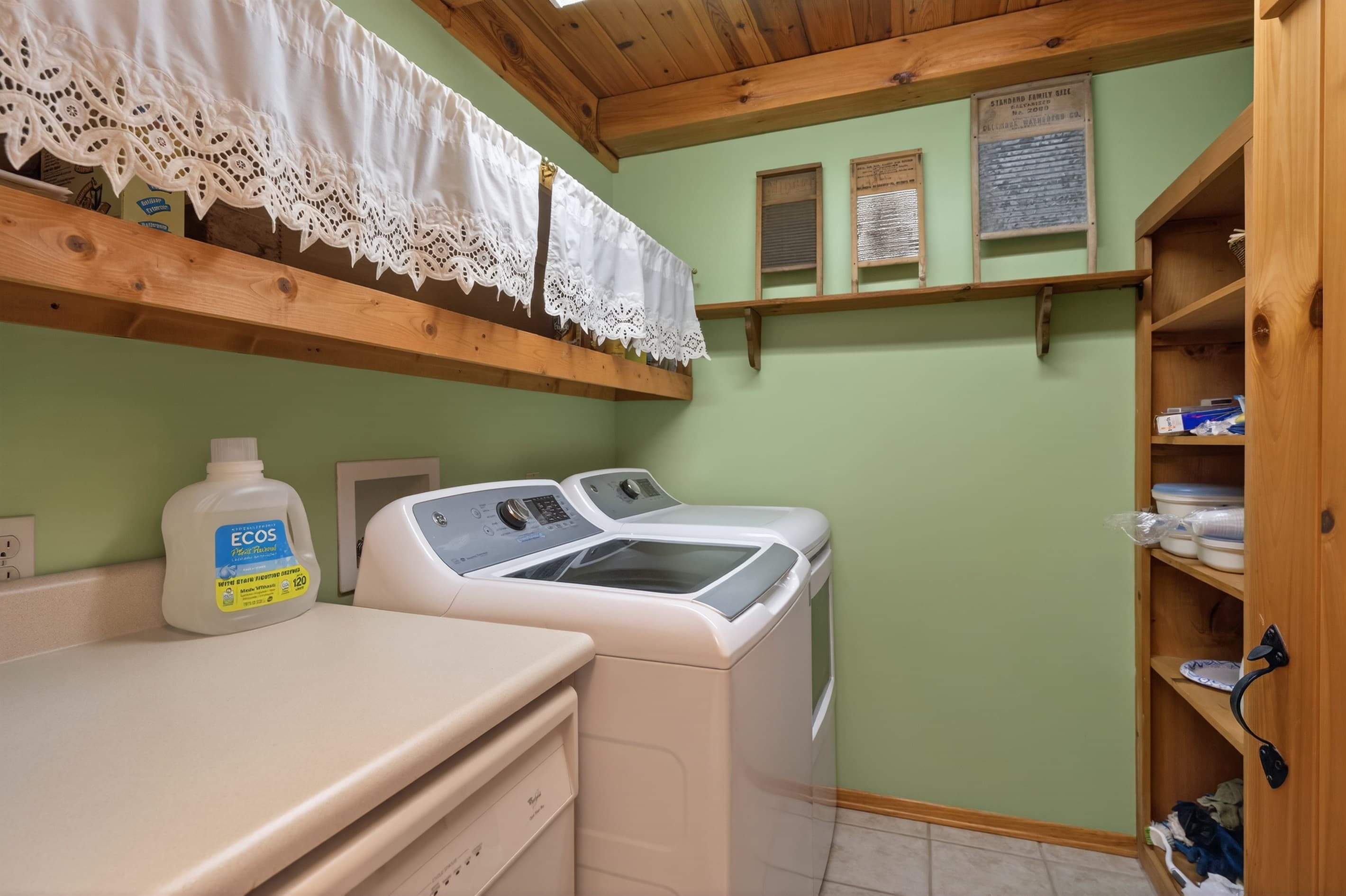 Laundry area with washer, dryer, and shelving