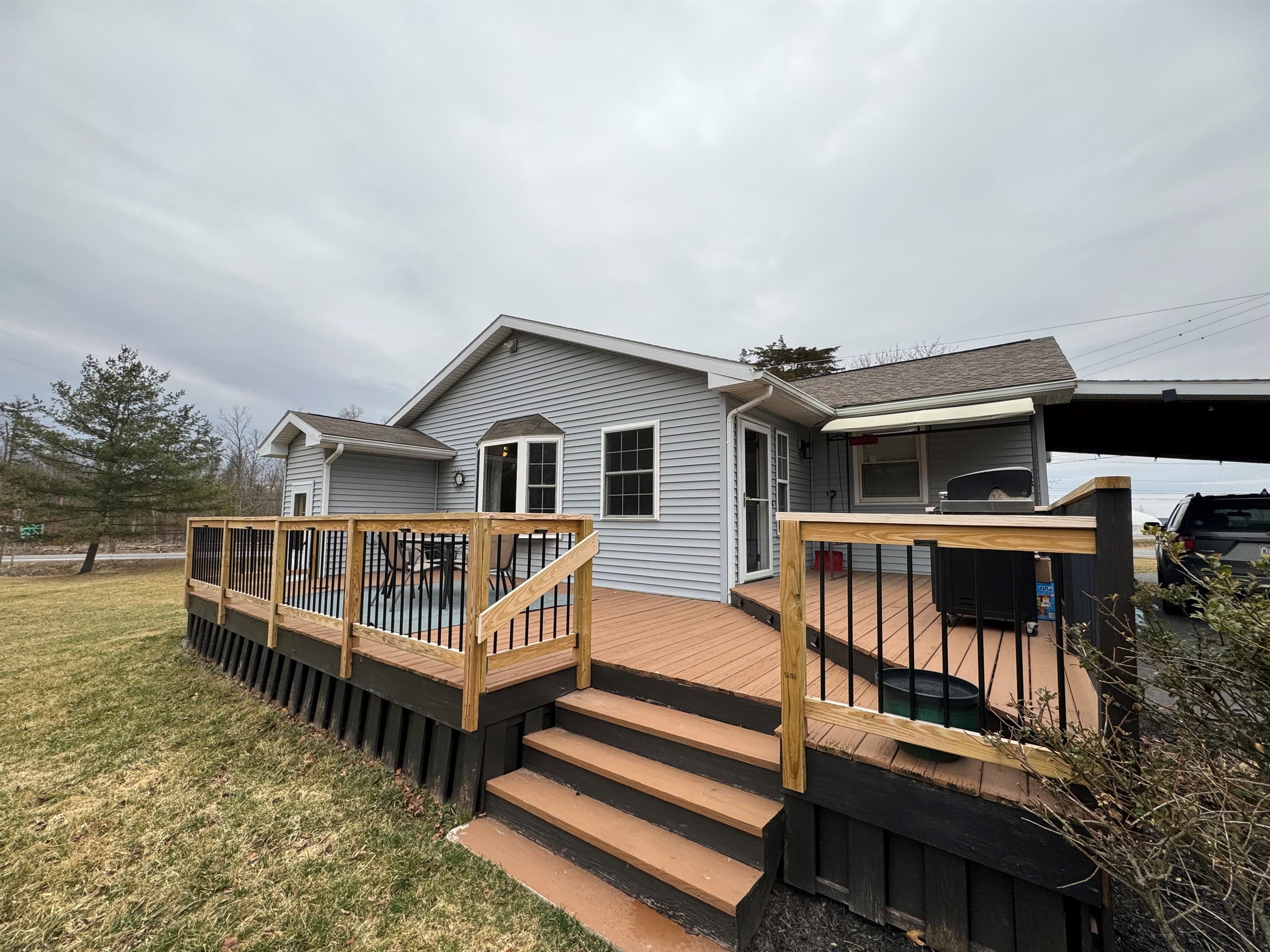 Home exterior with raised wooden deck