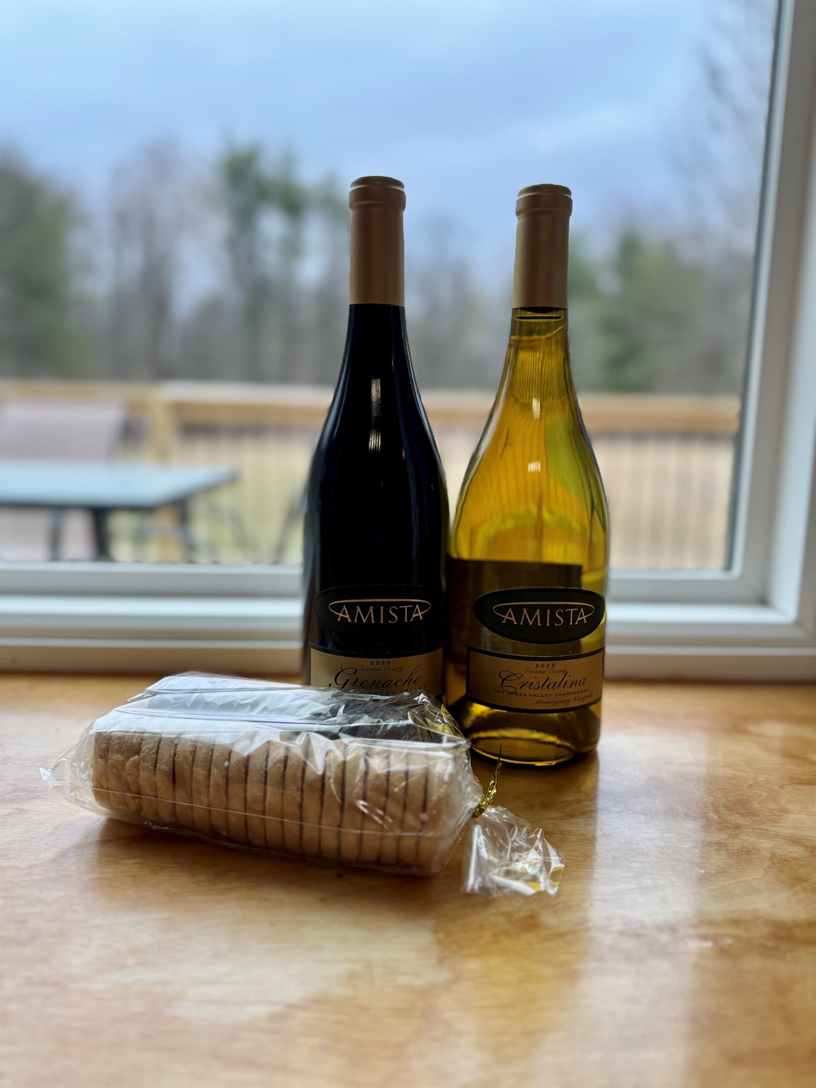 Wine bottles and crackers beside the window