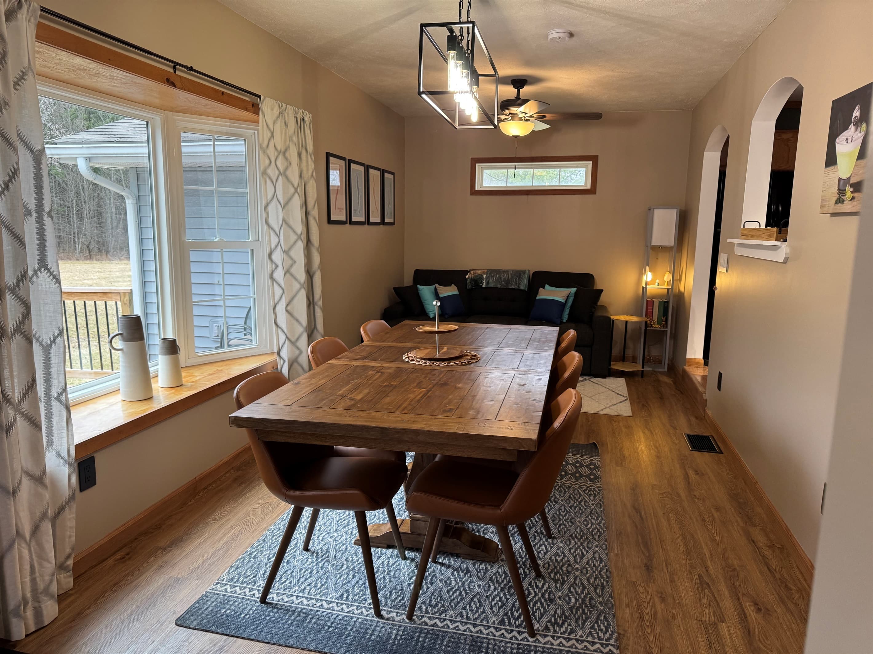 Dining table beside large windows