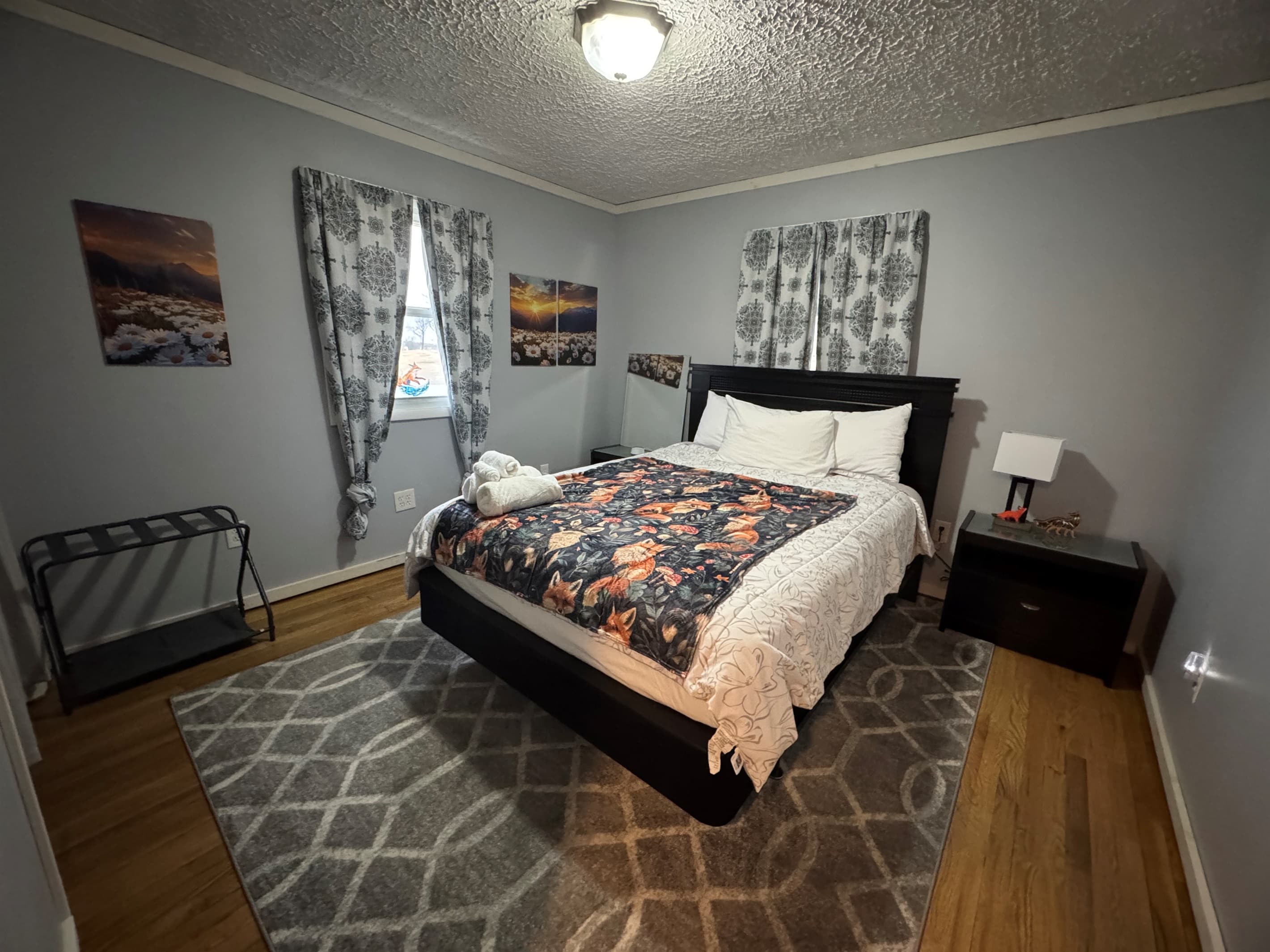 Bedroom with patterned curtains and two nightstands