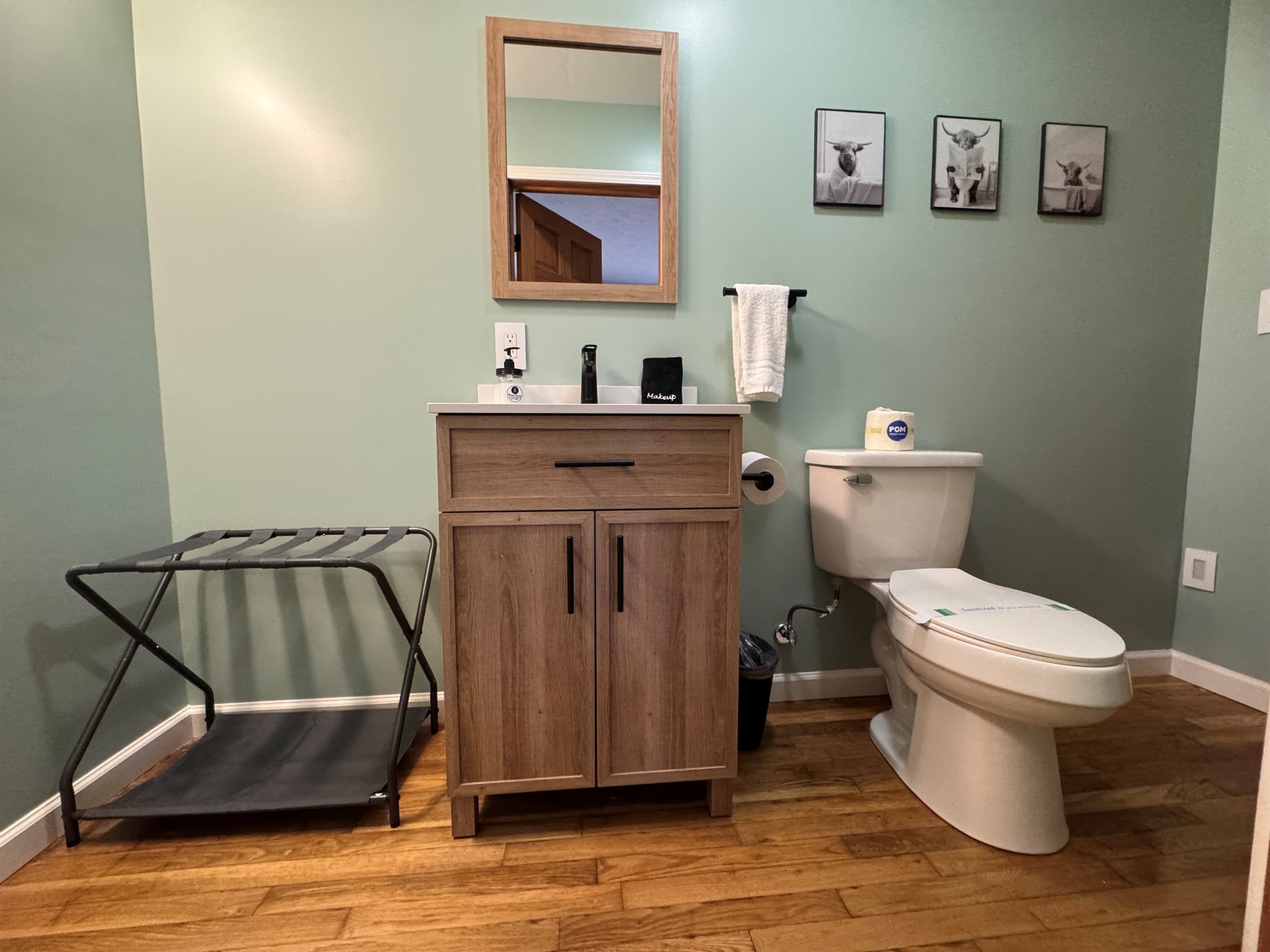 Half bathroom with wooden vanity and toilet