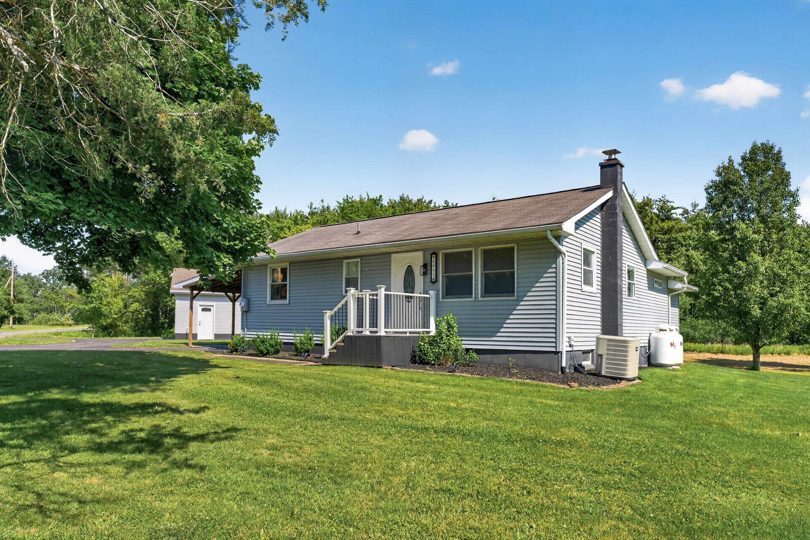 Side exterior with lawn and chimney