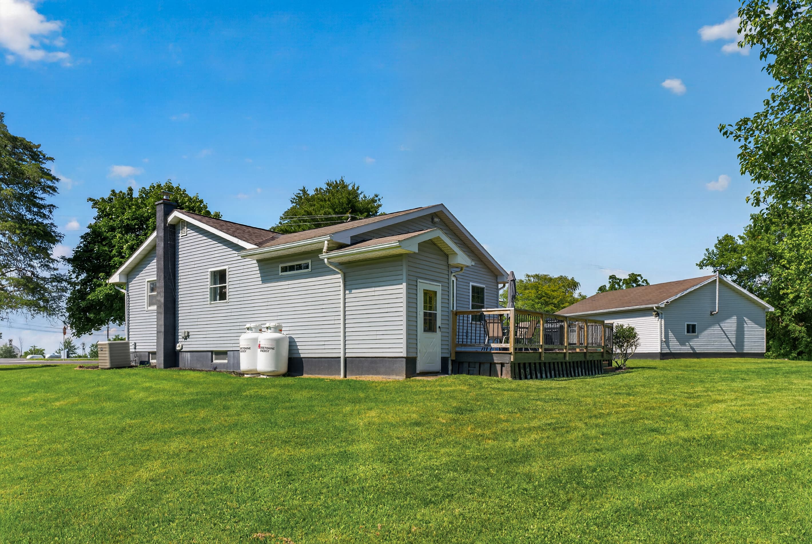 Home and detached building across the lawn