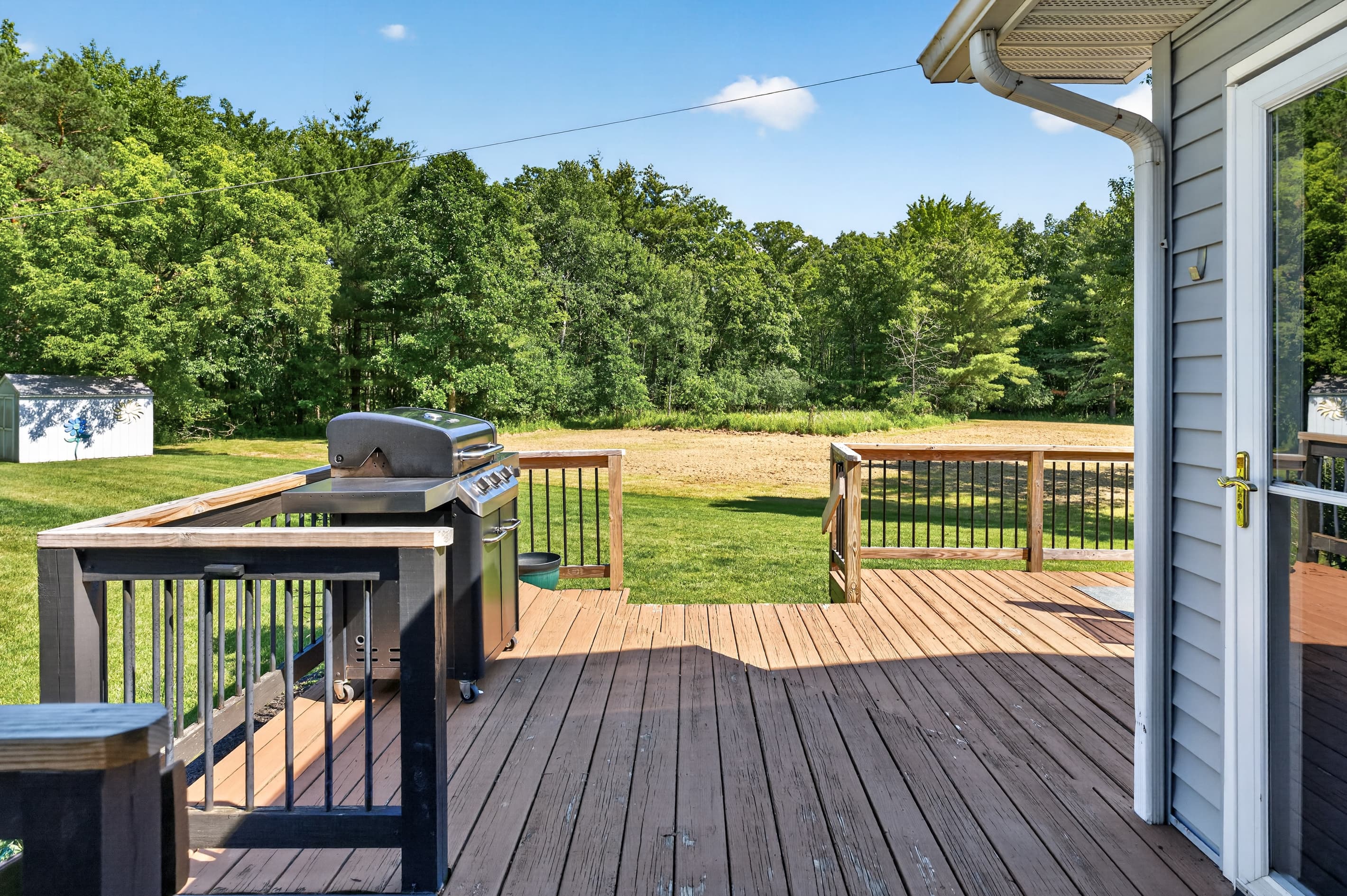 Deck with grill and steps to lawn