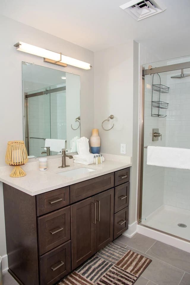 Bathroom vanity with dark wood cabinetry