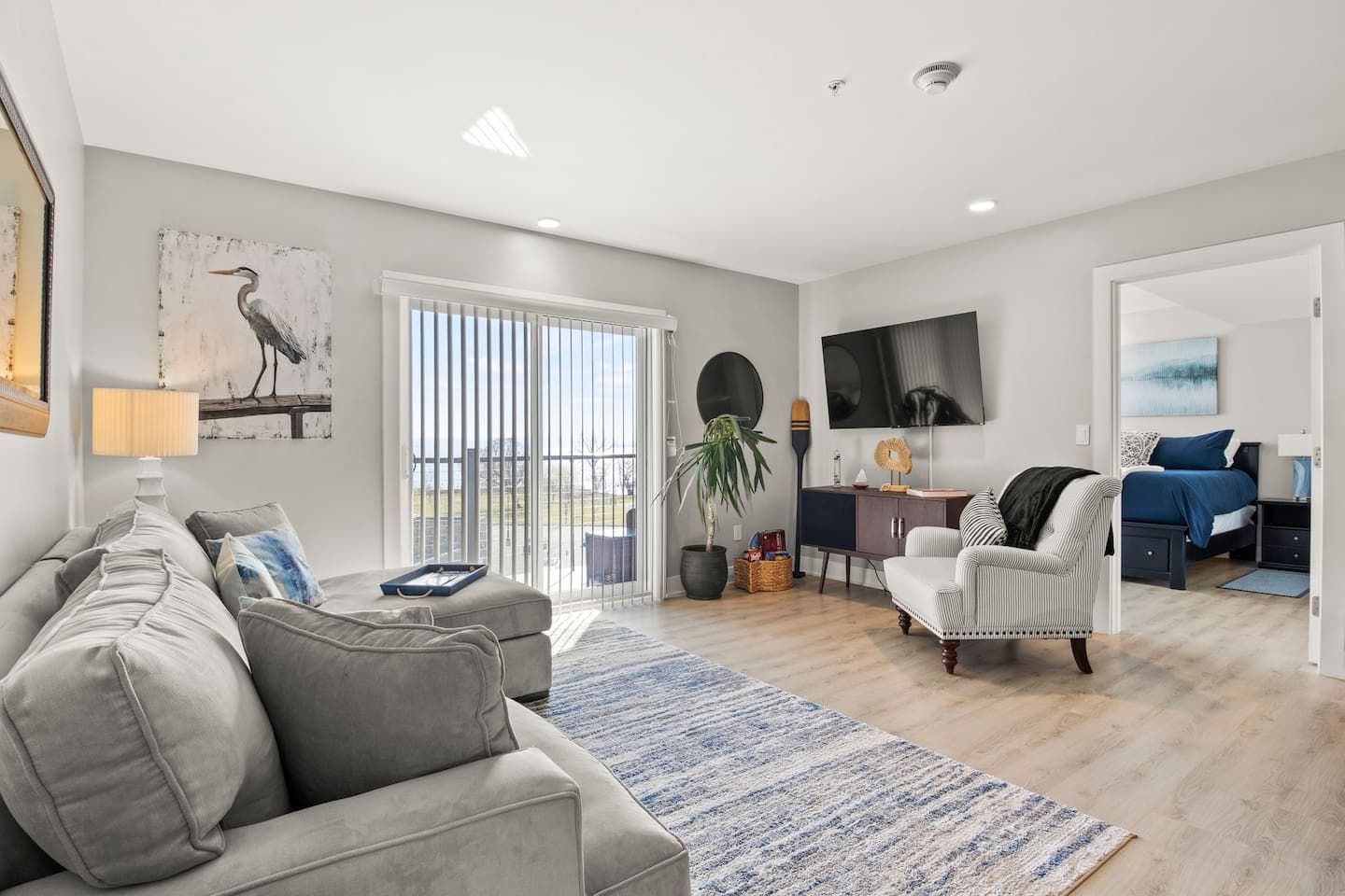 Open living room with sectional and wall mounted television