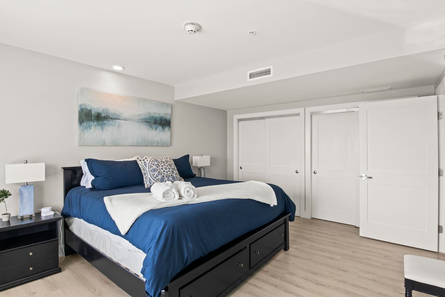 Bedroom with blue accents and closet doors