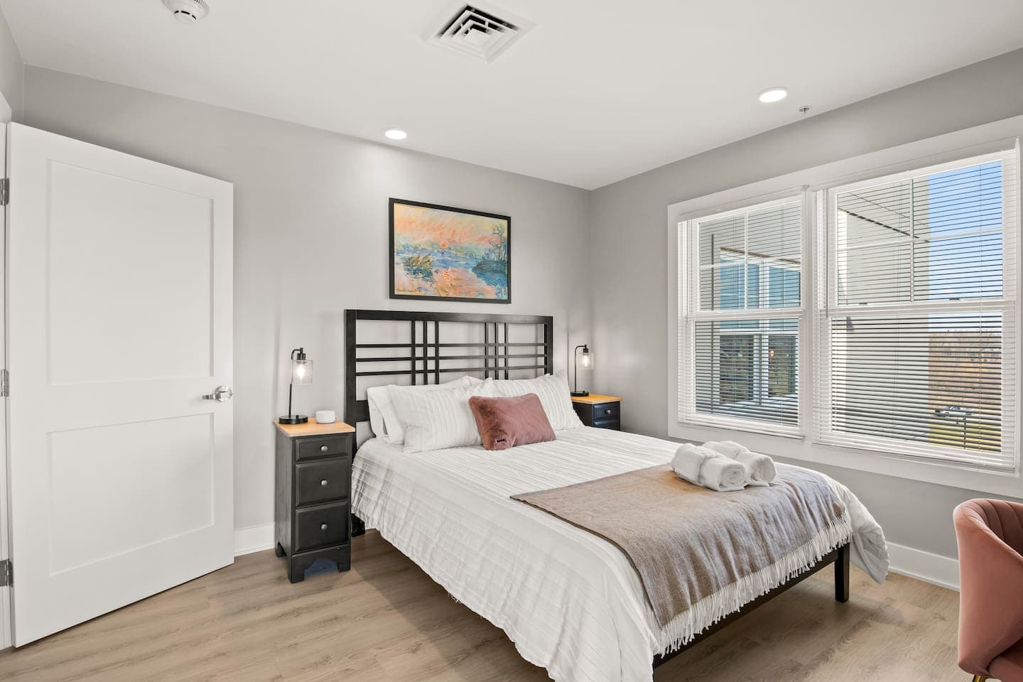 Bedroom with white bedding and wide windows