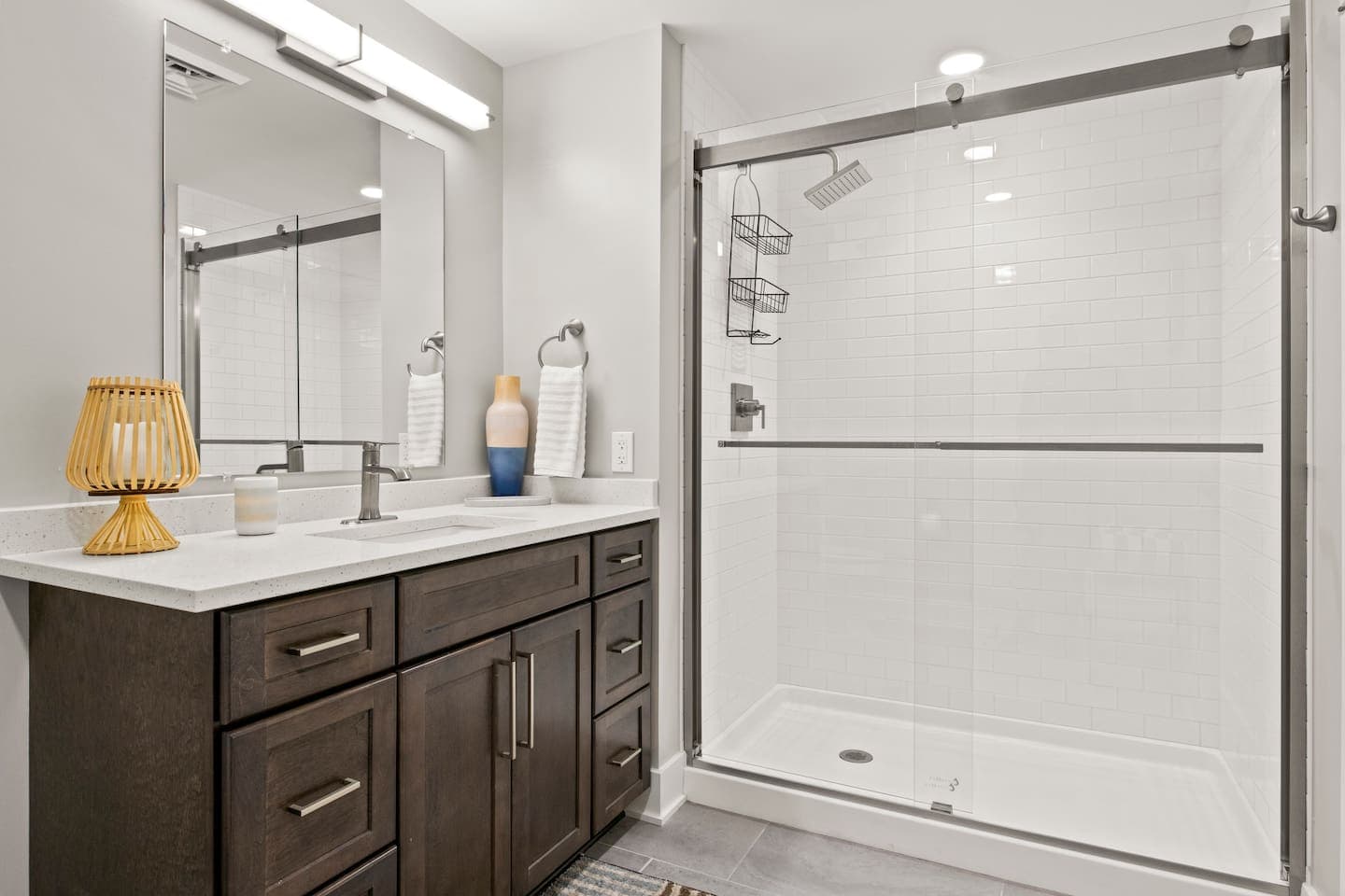Bathroom with glass-enclosed shower and vanity