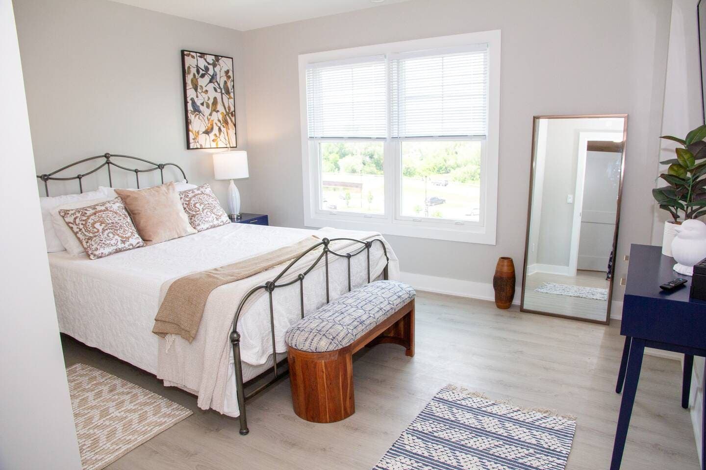 Bedroom with metal bed frame and large window