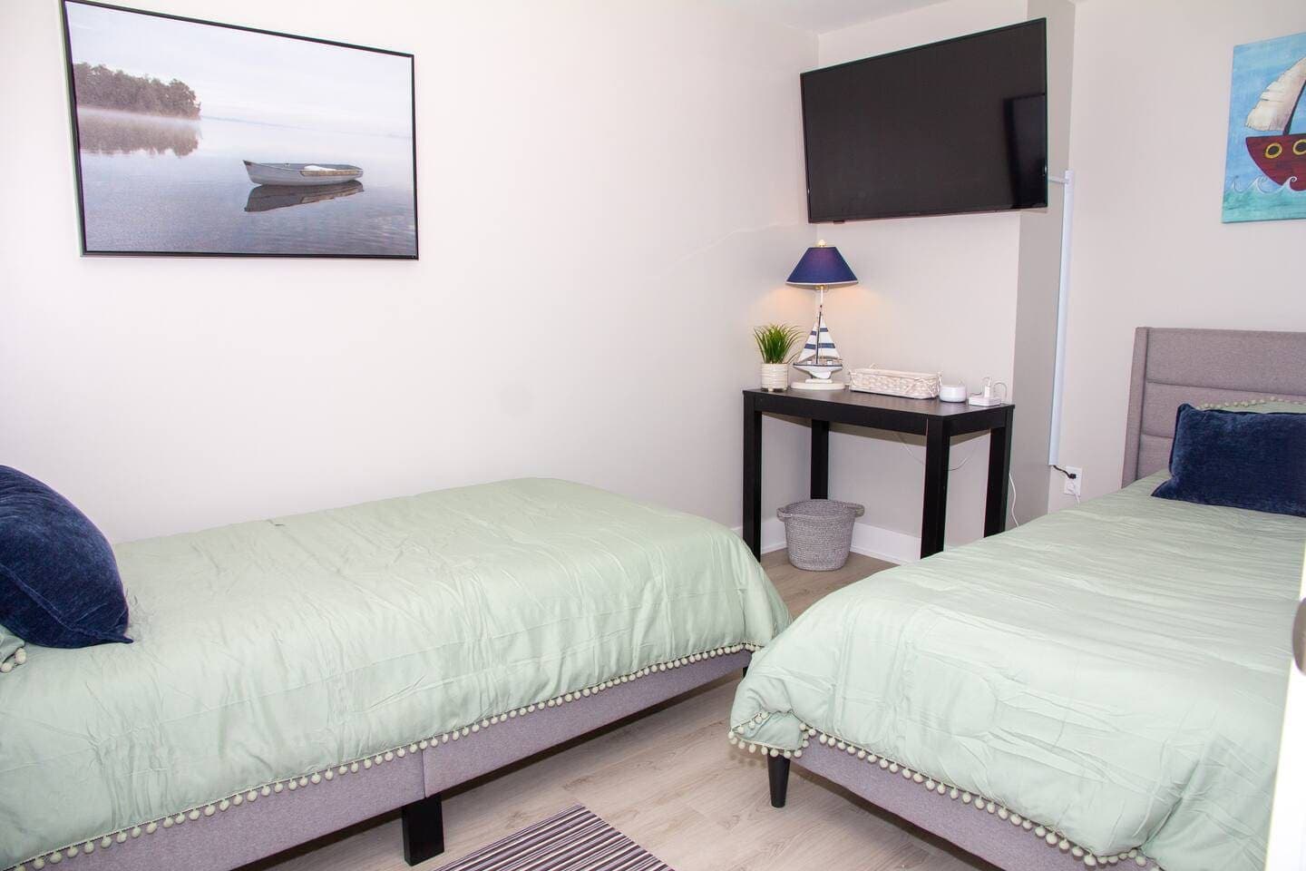 Bedroom with television and framed artwork