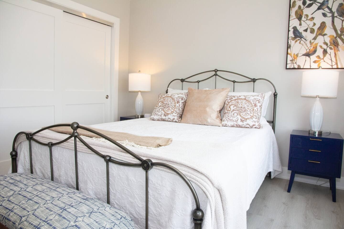 Bed with metal frame and bedside lamps
