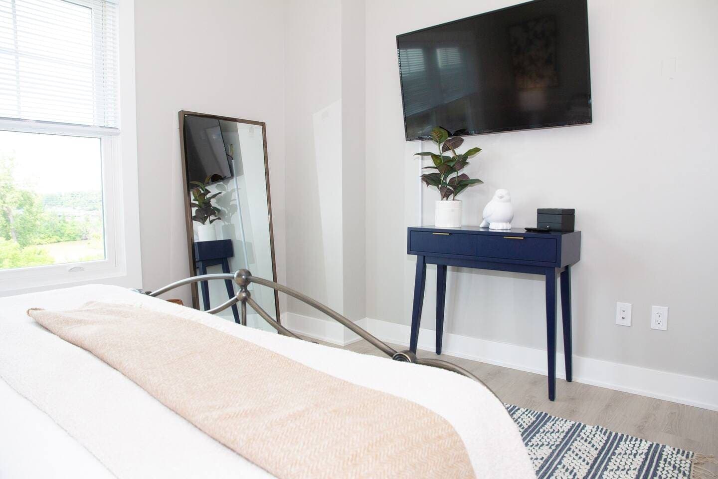 Full-length mirror beside the mounted television