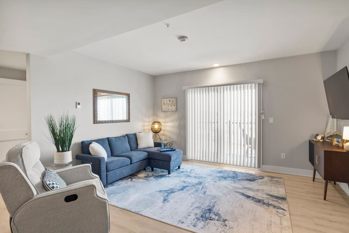 Living room with blue sectional and lazy boy chair