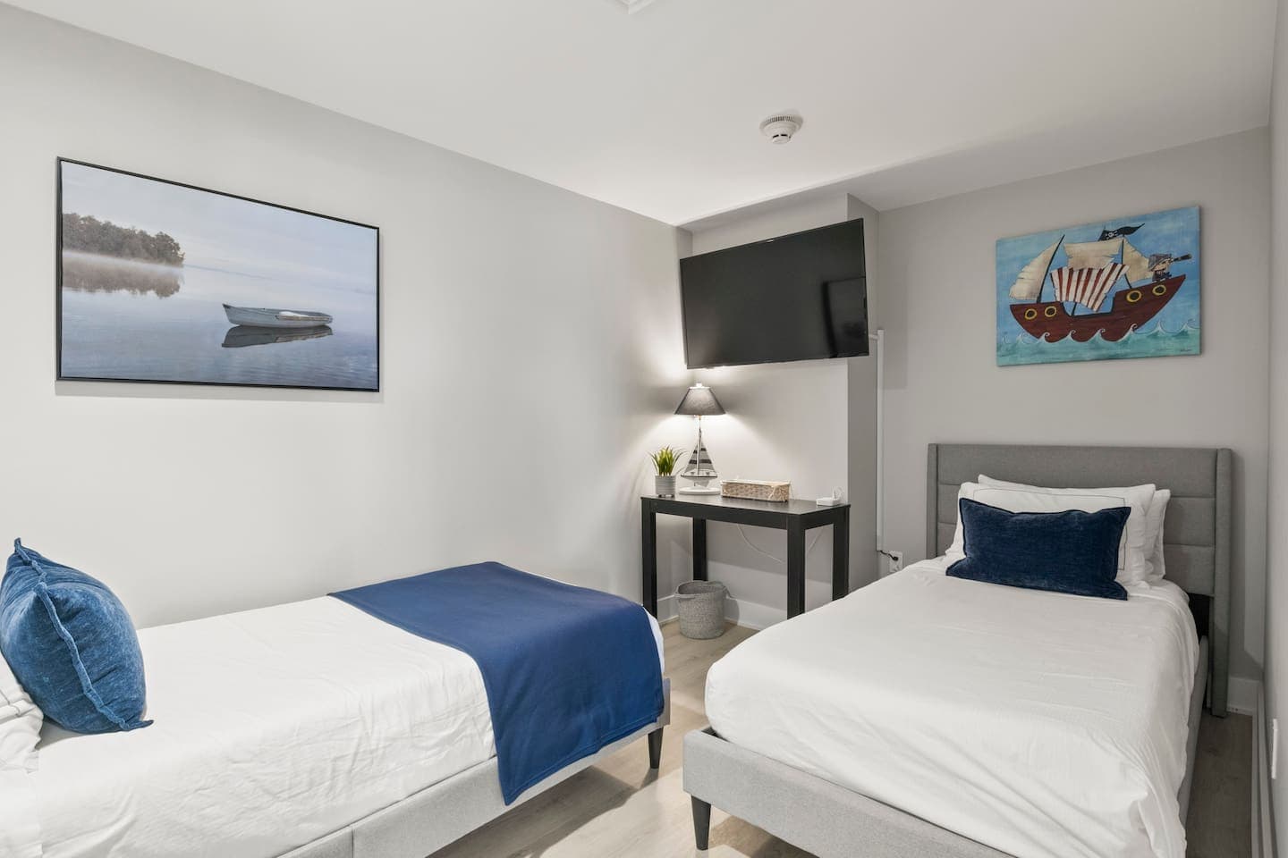 Bedroom with blue accents and grey bed frame