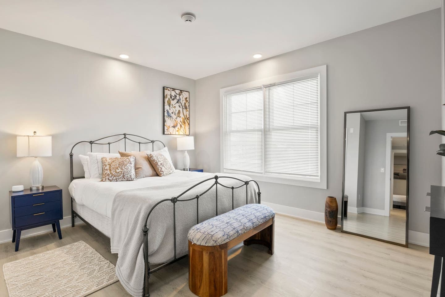 Bedroom with large window and full-length mirror