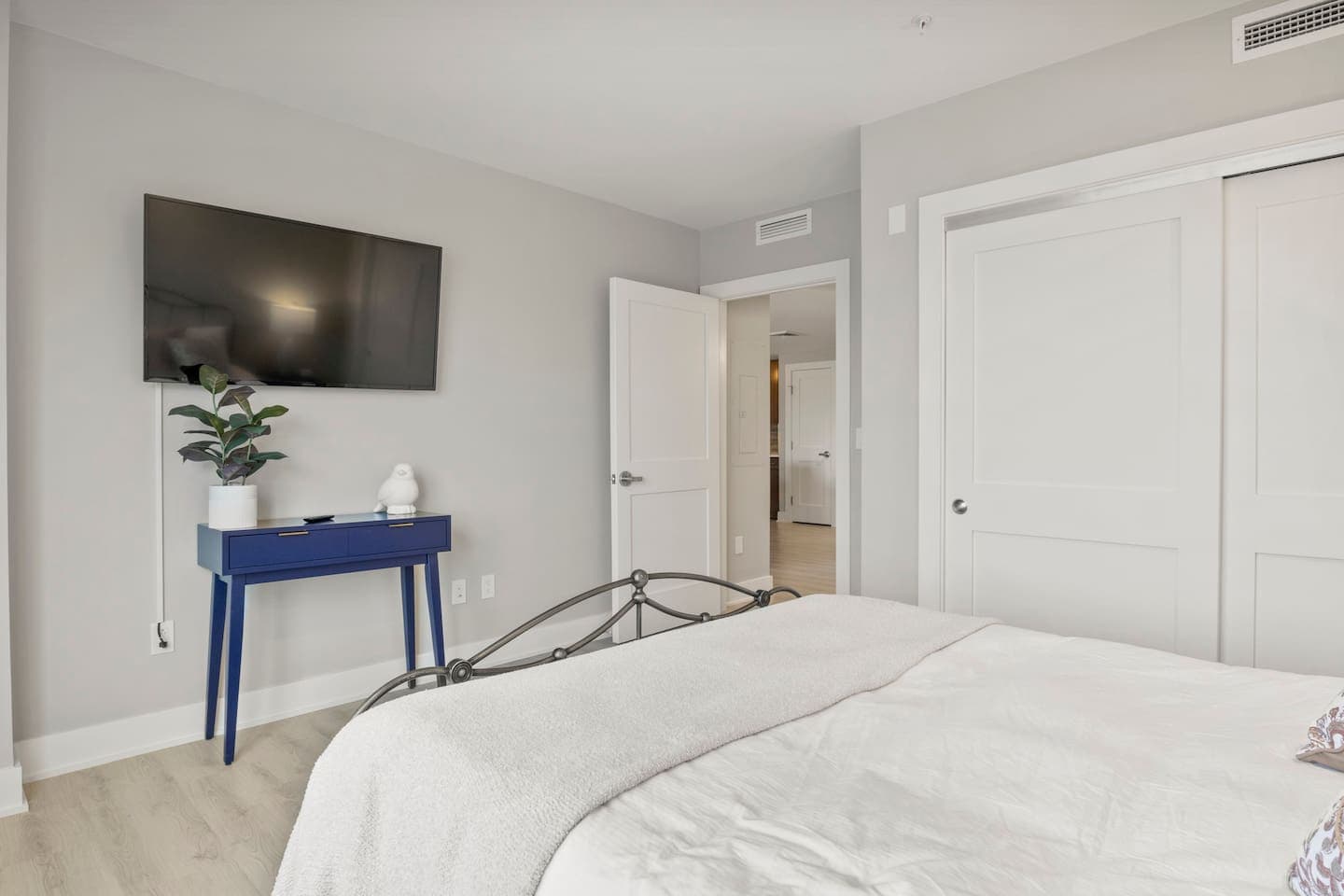 Bedroom television above a compact desk