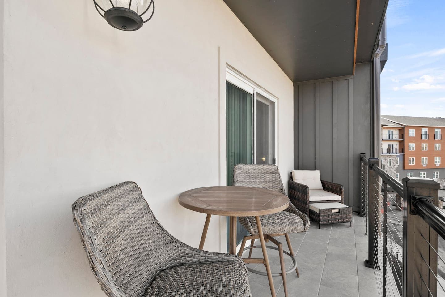 Balcony with round table and cushioned seating