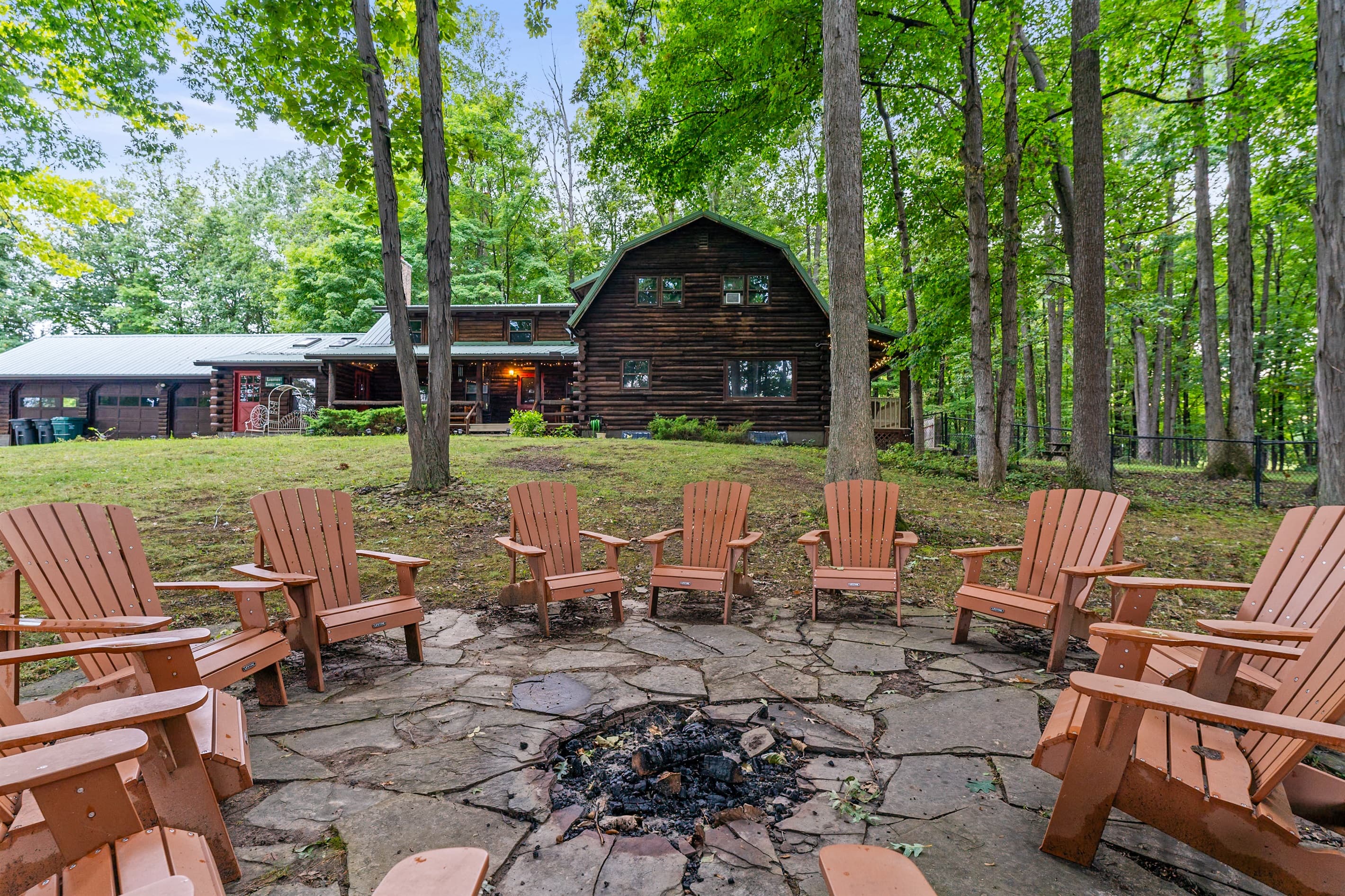 Wooded fire pit area with outdoor seating