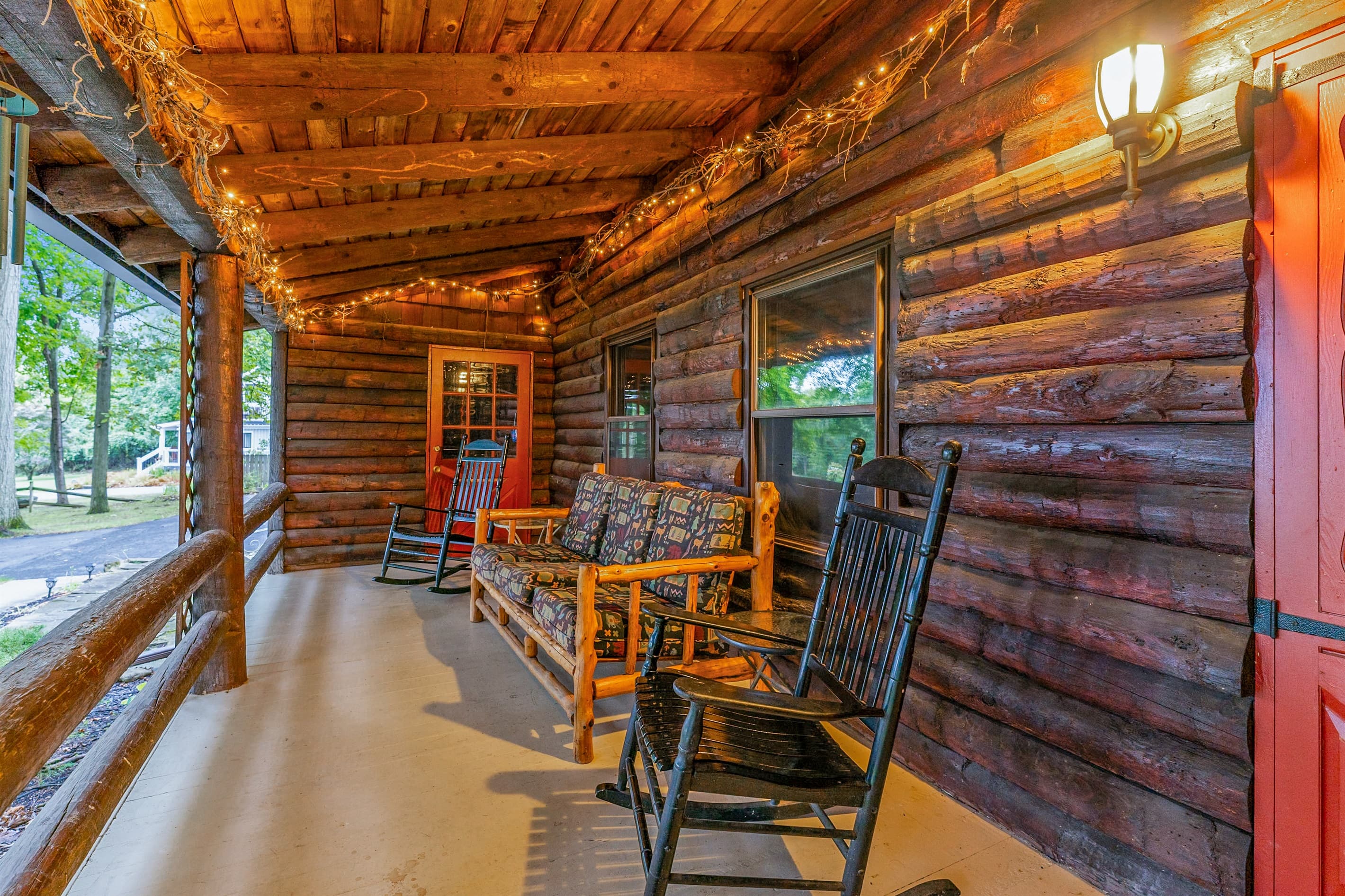 Covered porch with wooden outdoor furniture