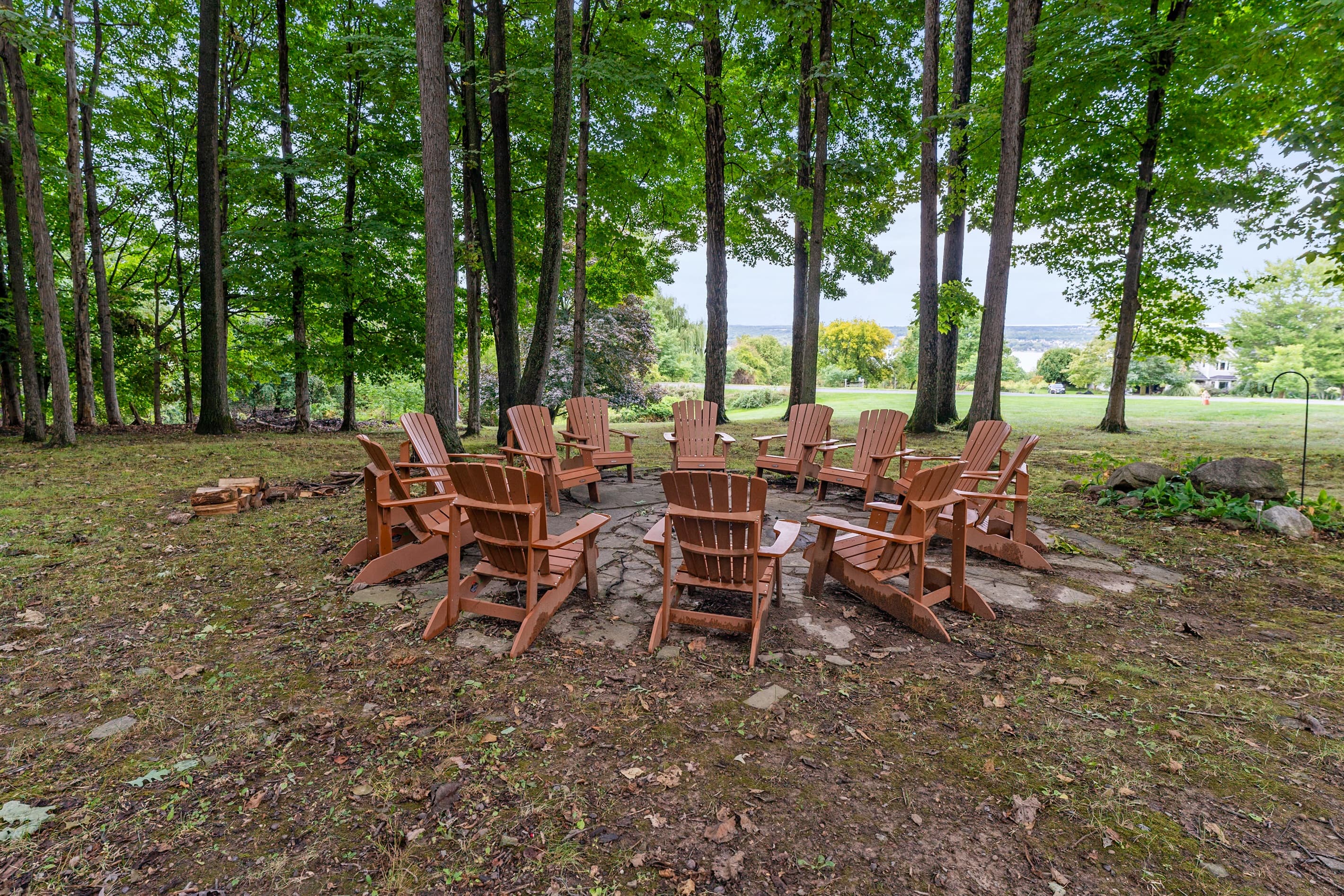 Fire pit seating beneath mature trees